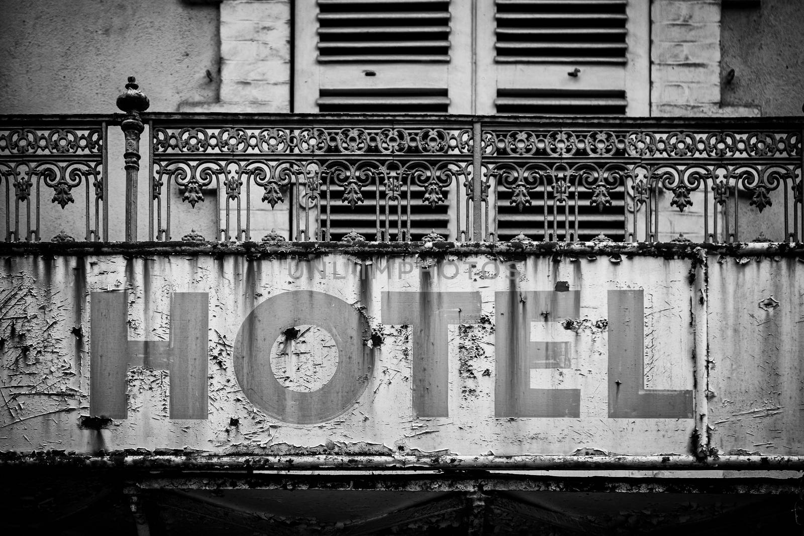 Sign of a broken and abandoned hotel, detail of an old information, crisis and ruin
