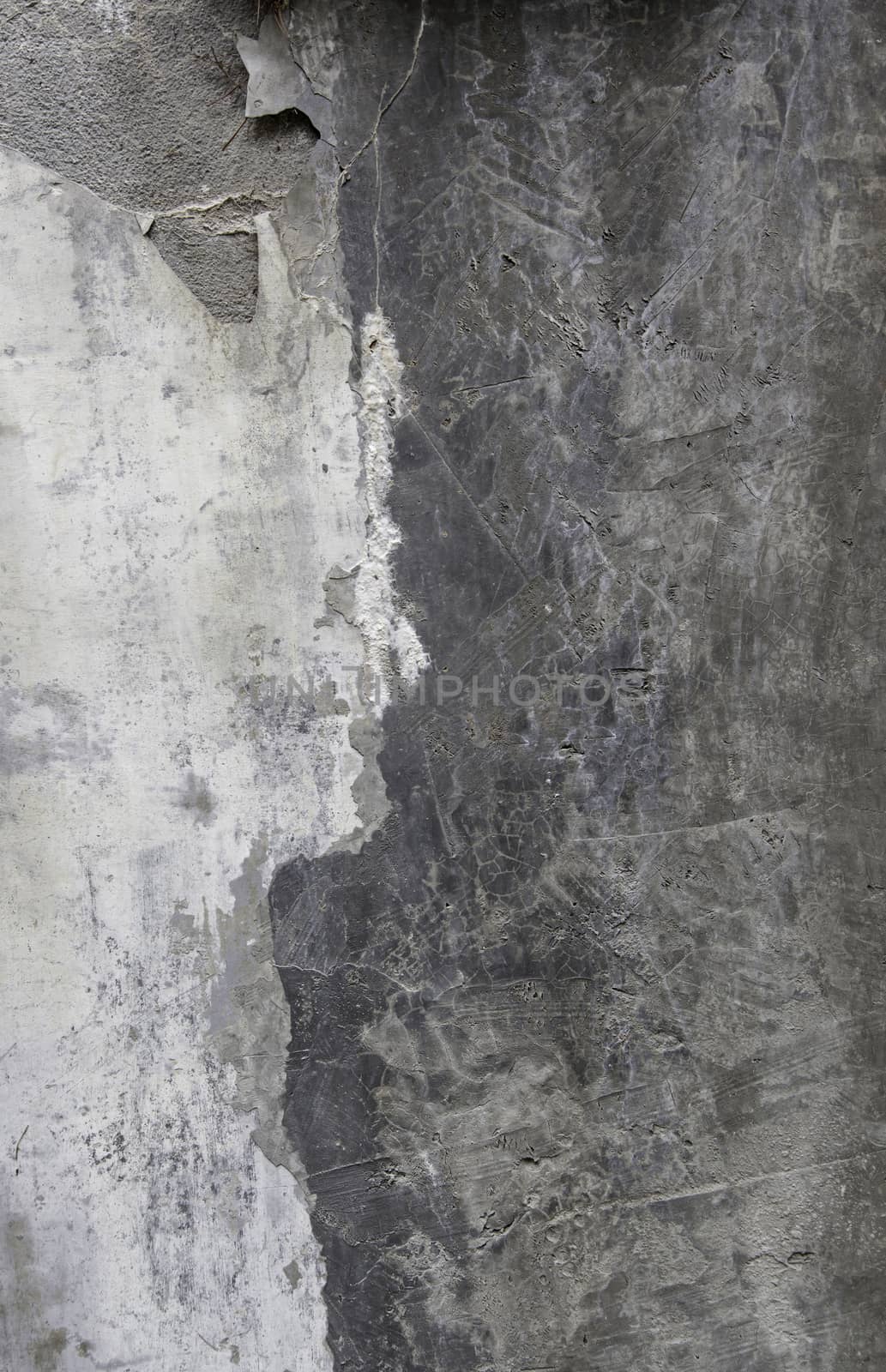 Old concrete wall damaged by time, detail of ruin and abandonment in the city