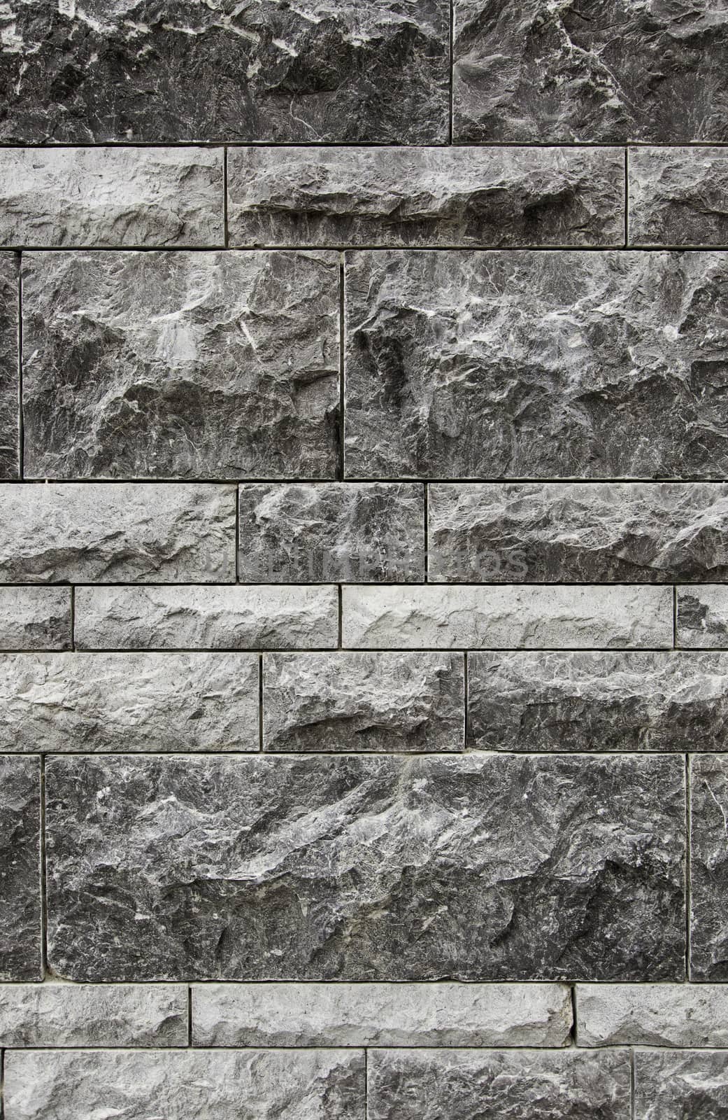 Wall decorated with natural stones, detail of a textured background
