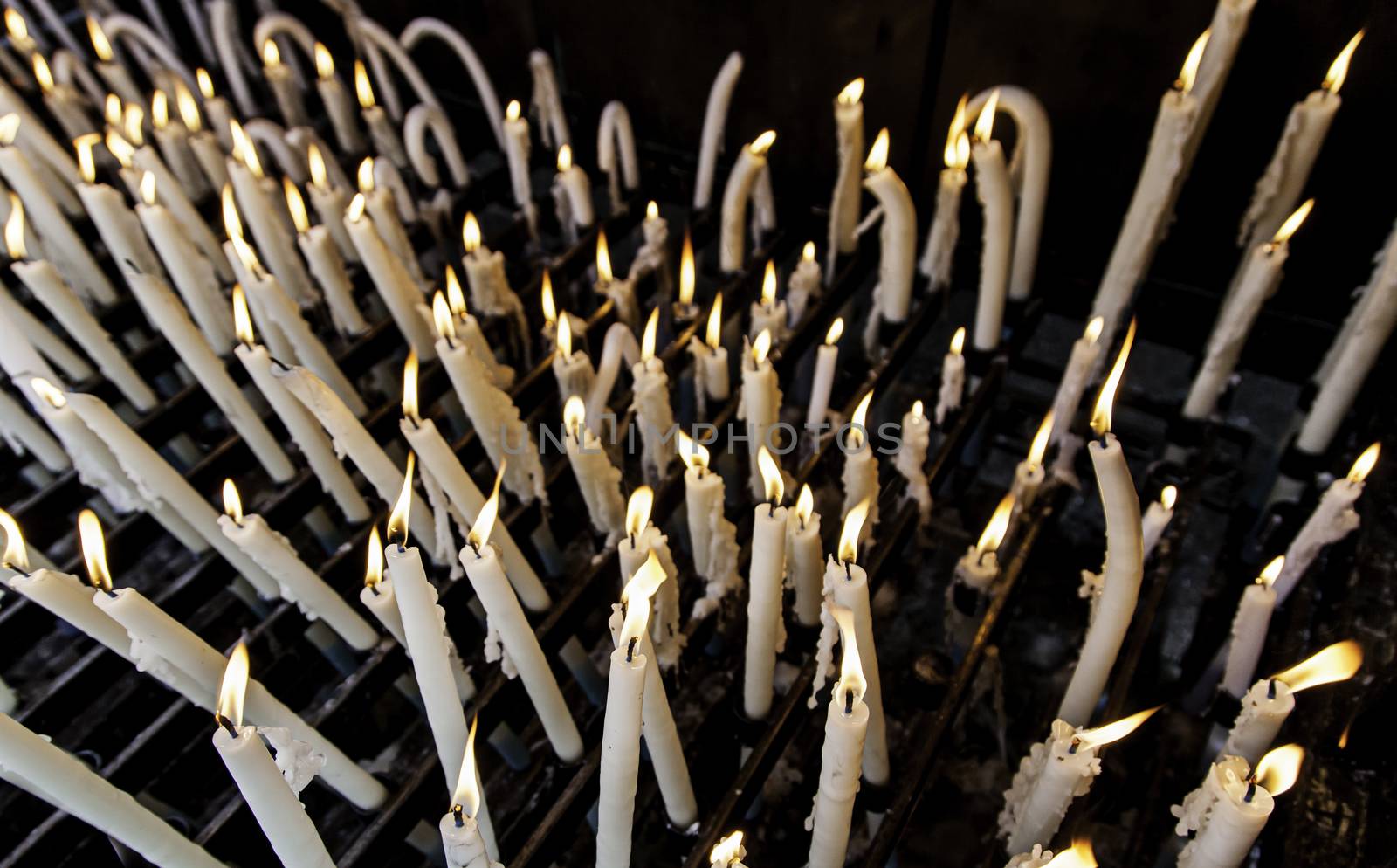 Wax candles burning in a Christian tradition, flame and faith