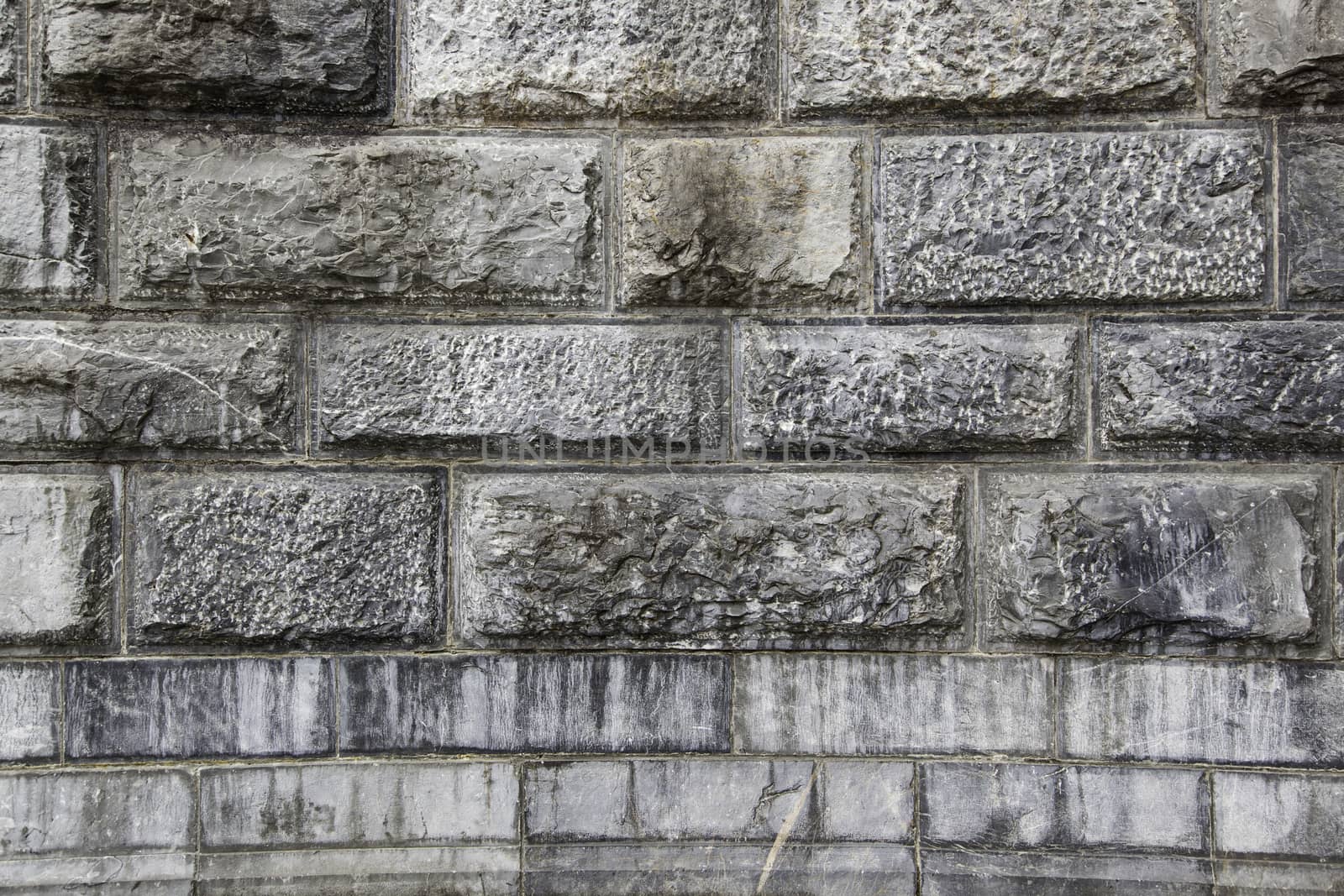 Wall decorated with natural stones, detail of a textured background
