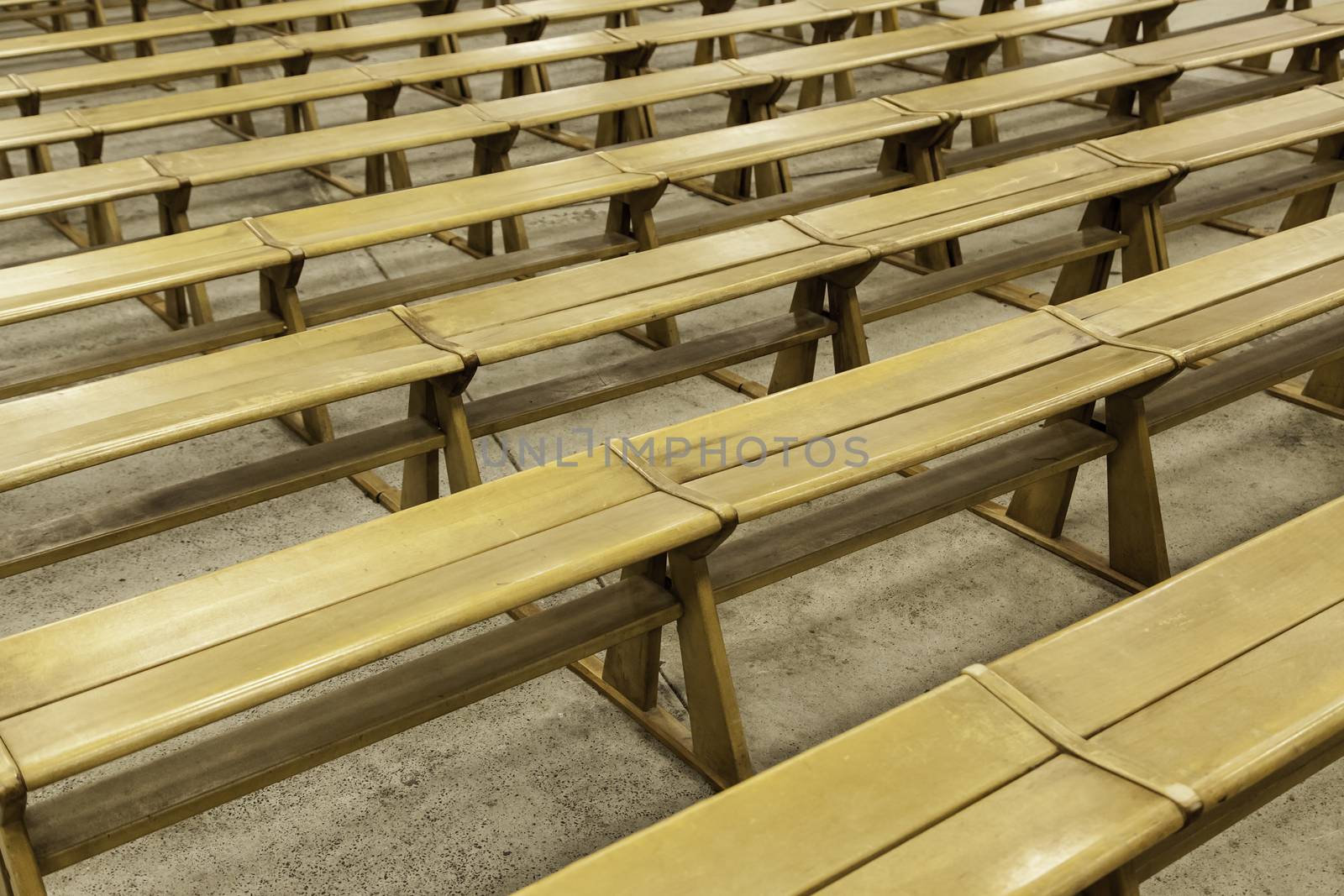 Old wooden benches in a church, detail of place to sit and pray