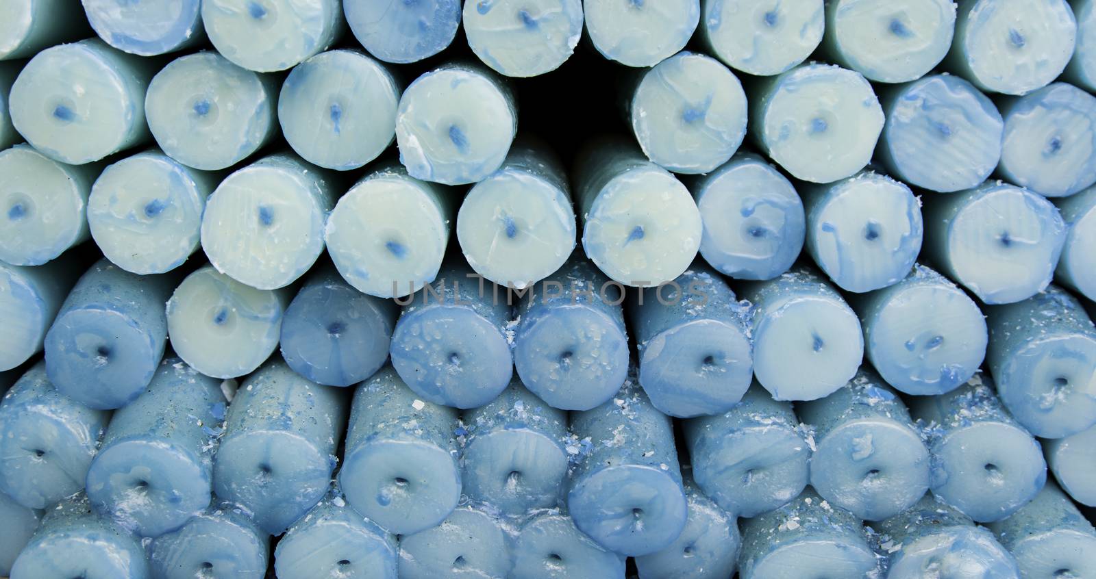 Blue candles, candle wax detail, artificial lighting