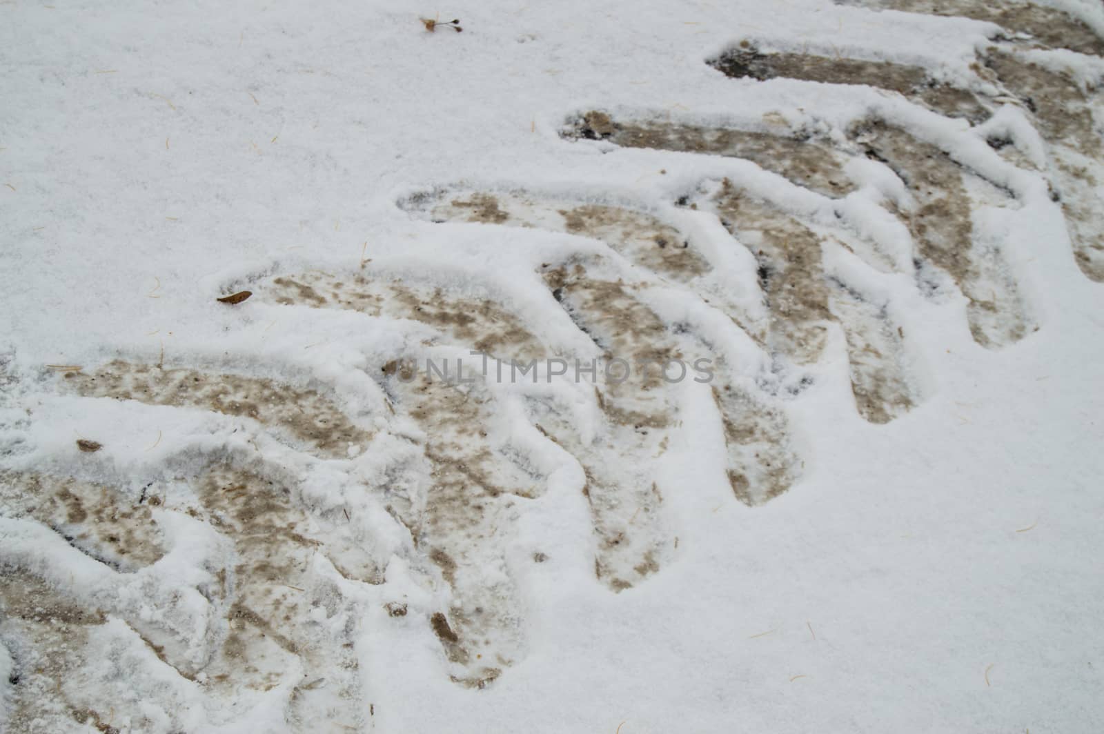 Abstract winter background on snow, close-up of the track from the car tire tread.