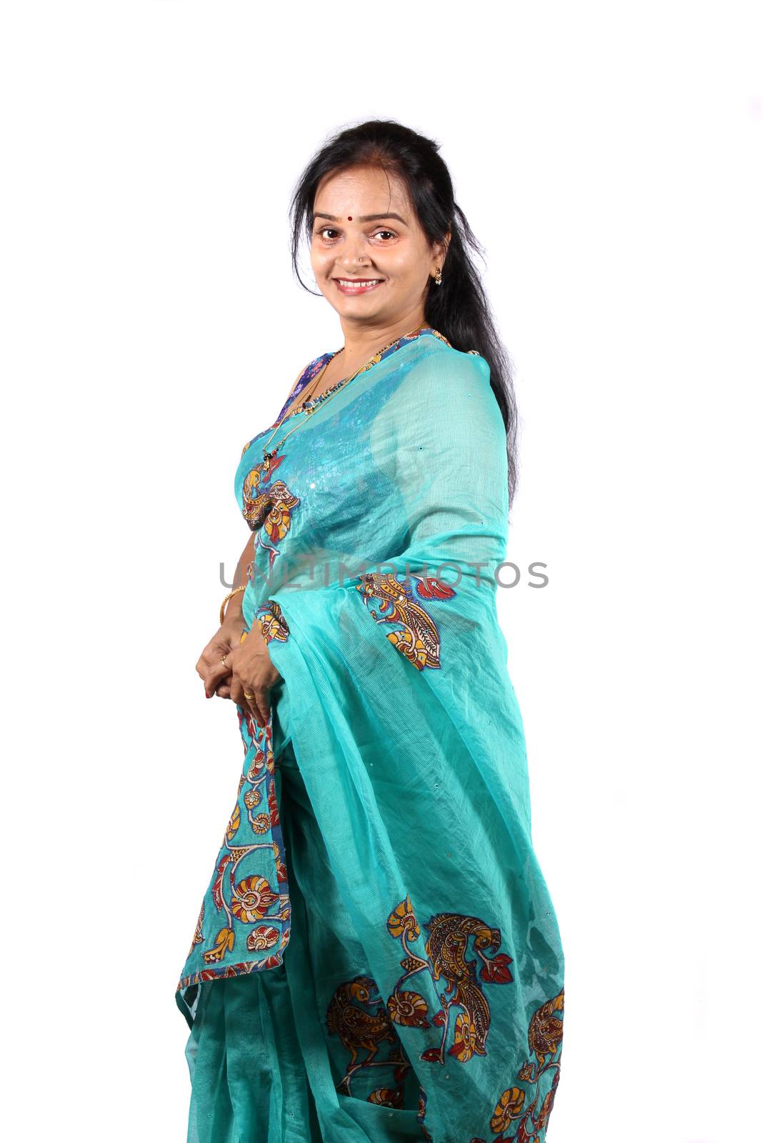 A beautiful Indian woman in a traditional saree, on a white studio background.