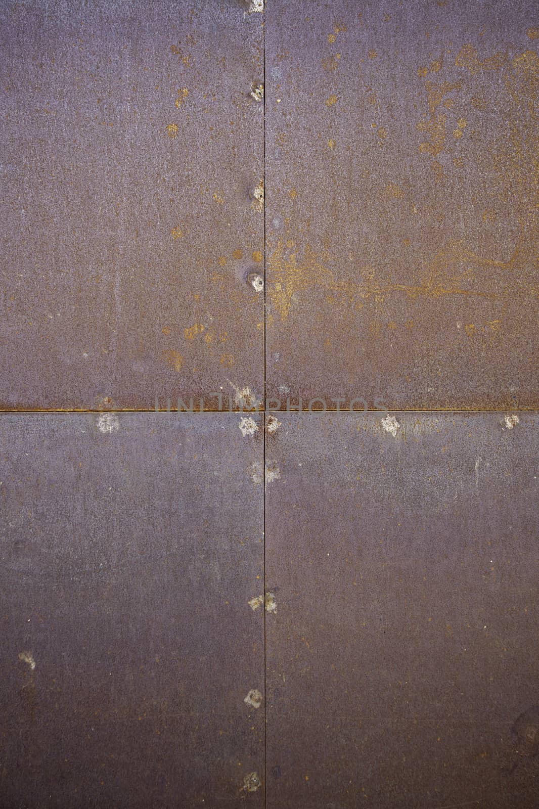 Metal wall section detail of the city wall, rusty metal on the street