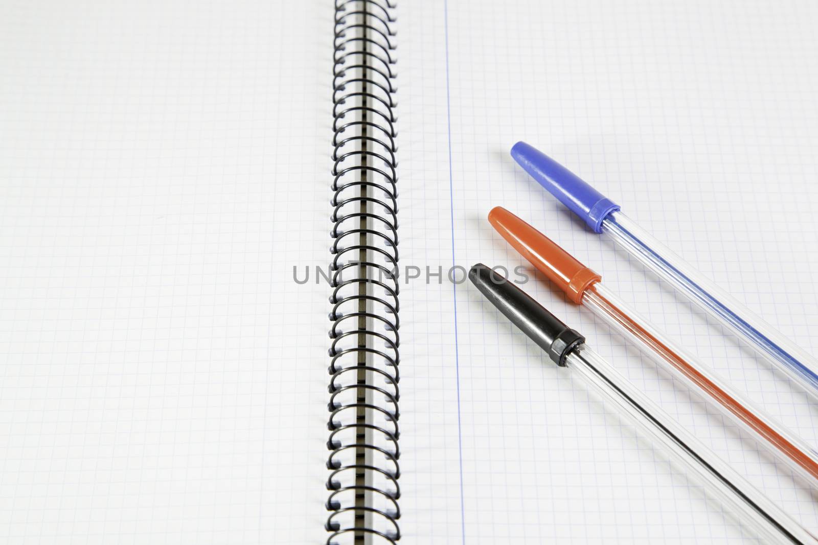 Three basic color pens on a notebook by esebene