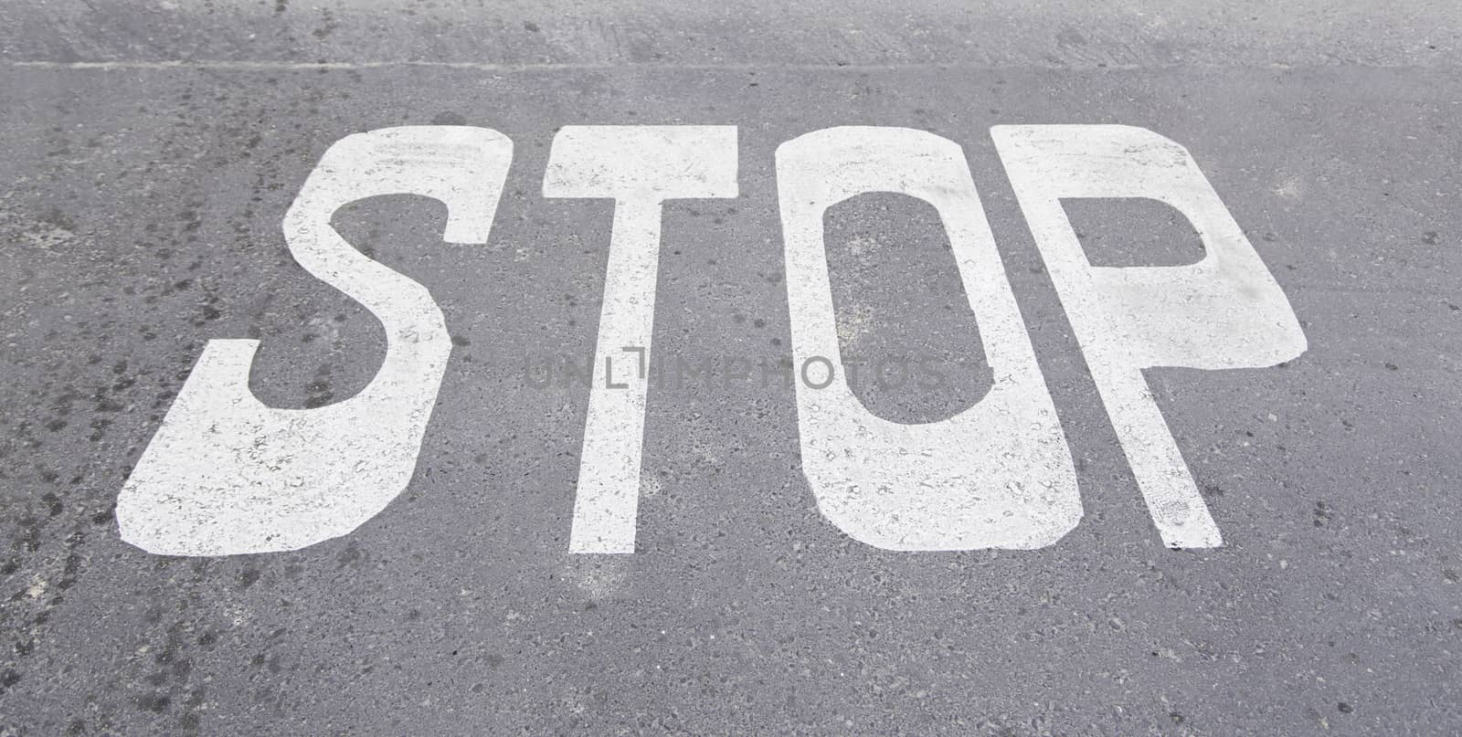 Stop sign on asphalt, detail of a traffic signal, security and prohibition