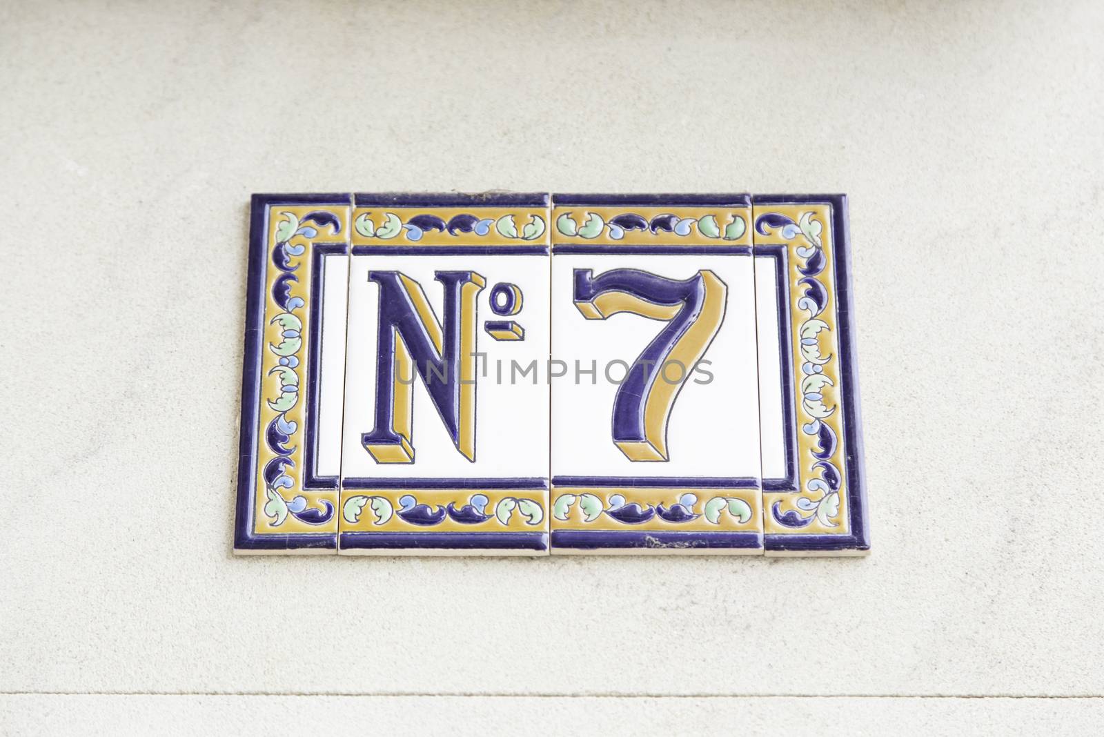 Number seven on the wall of a house, detail of a number of information, odd number