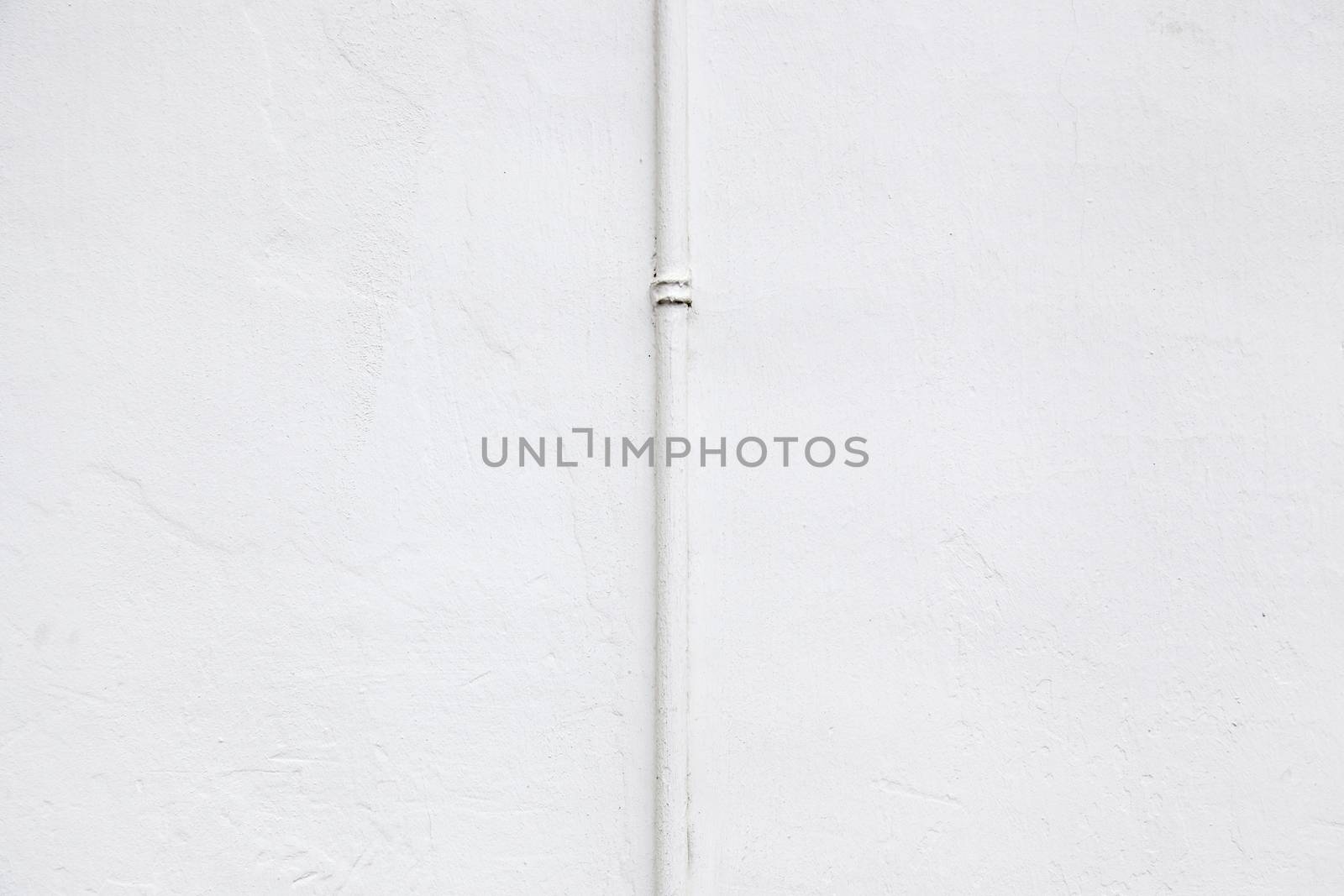 White wall with pipe, detail of a facade