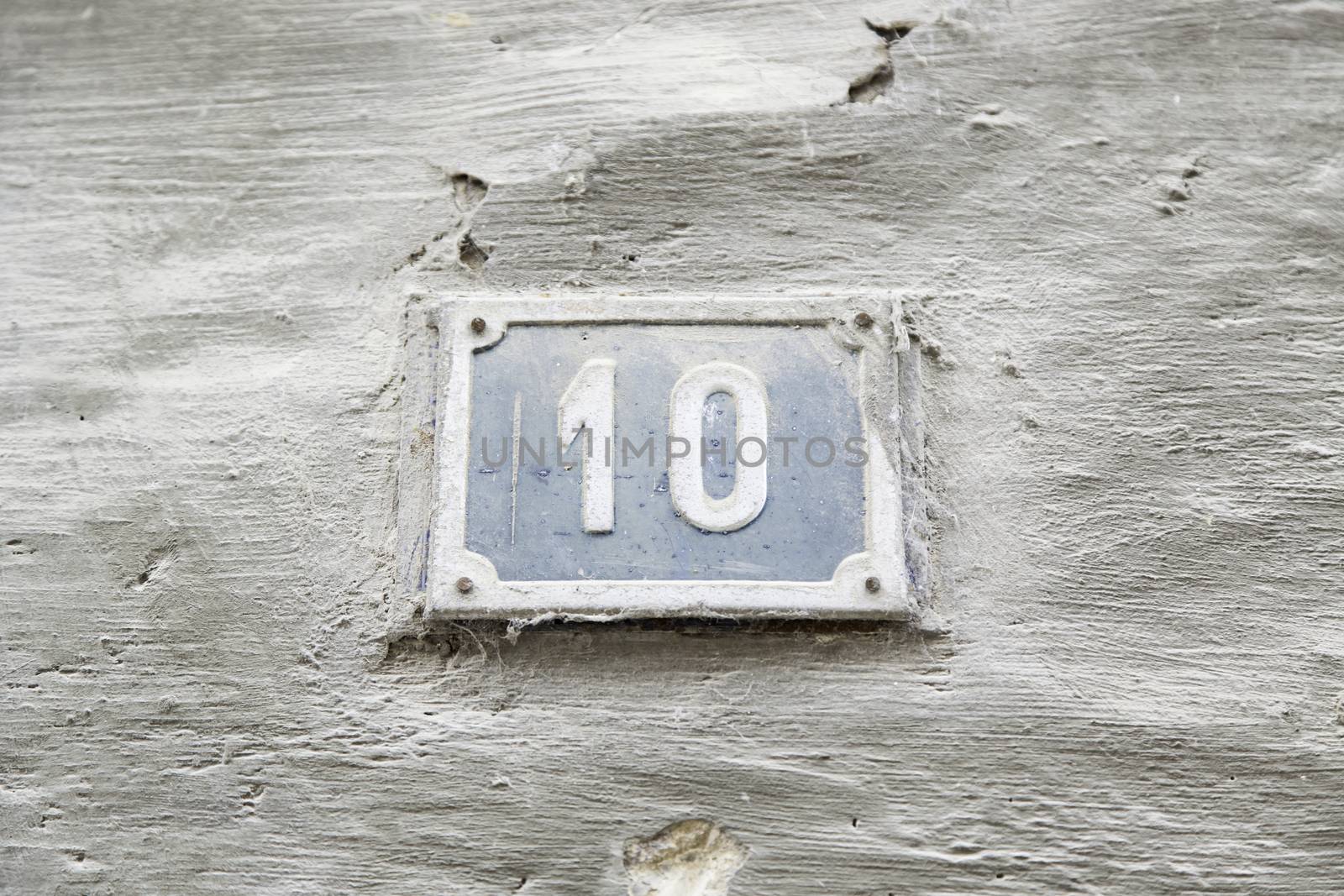 Number ten on the wall of a house, detail of a number of information, even number