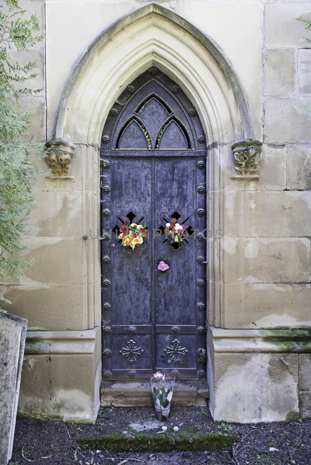 Old gate of a funeral pantheon, detail of edification for dead, graveyard
