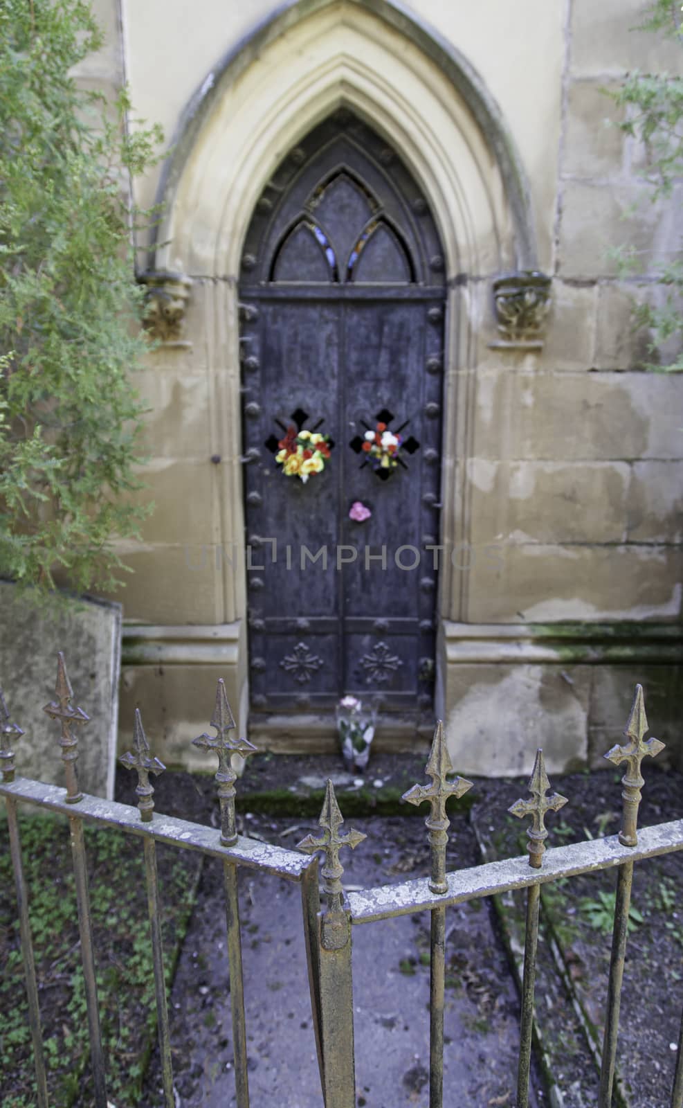 Old gate of a funeral pantheon, detail of edification for dead, graveyard