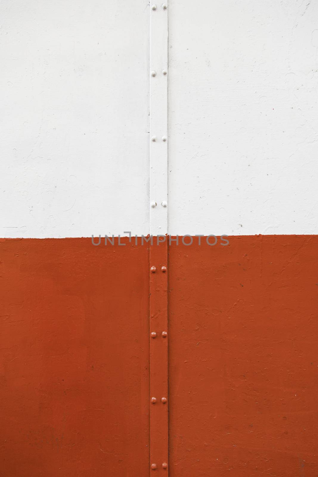 White wall with a pipe, detail of a textured wall