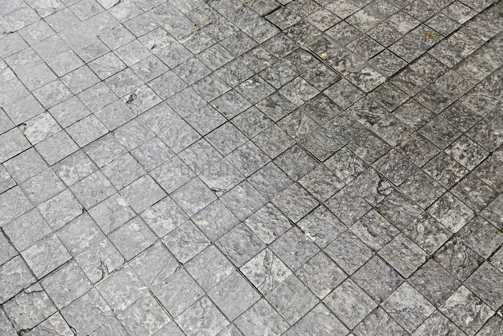 Floor wet cobblestones, detail of a textured, soil Street