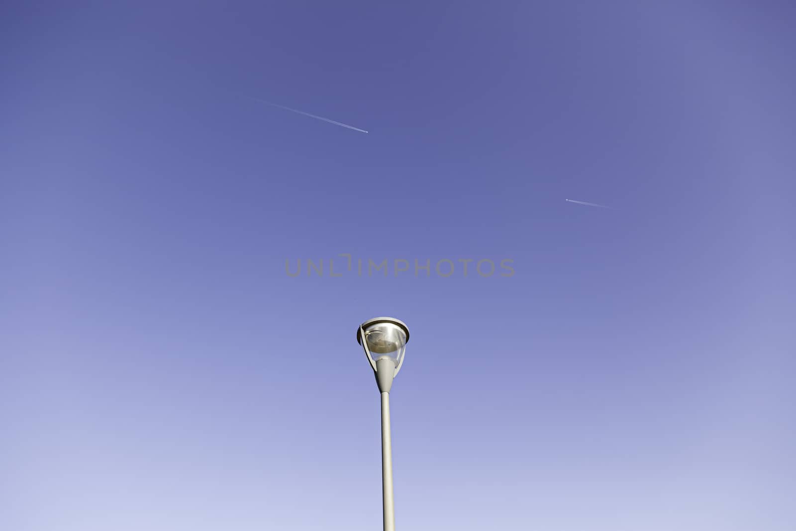 Lamp and planes in the sky, detail of air traffic, transportation