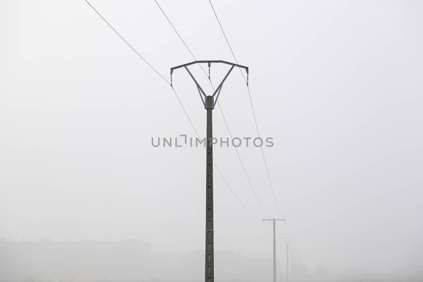 Electrical towers in the fog, detail of electric transport, energy