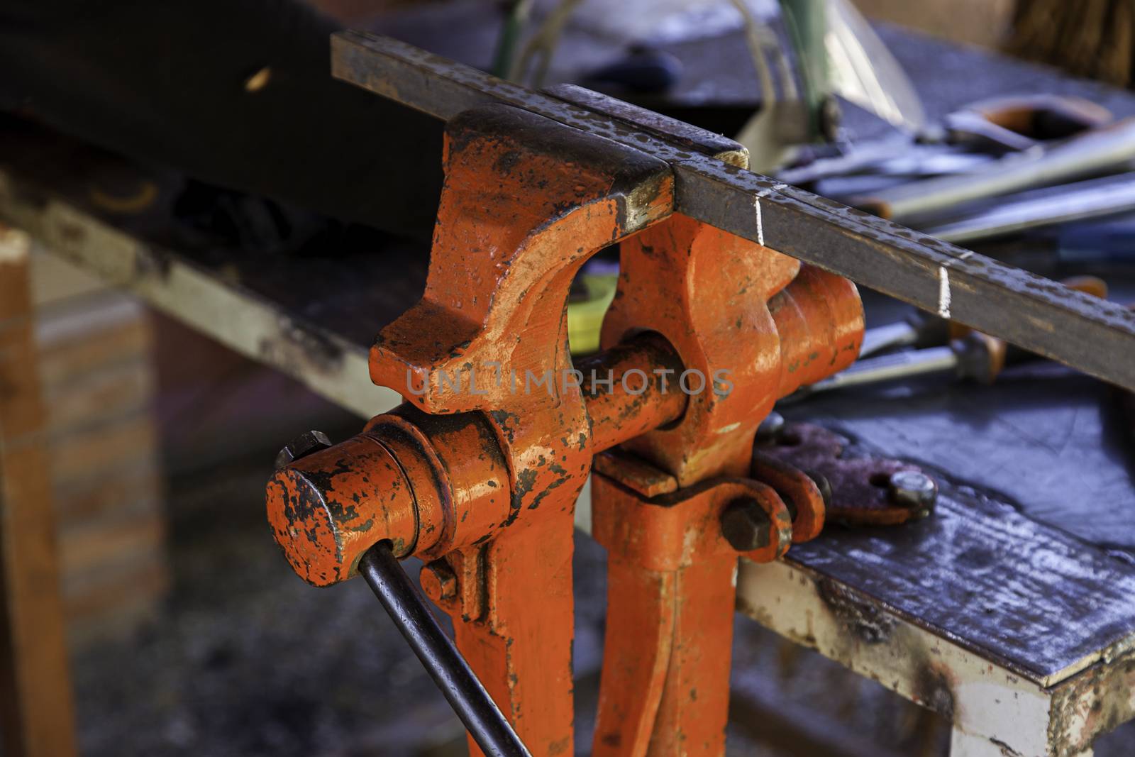 Old metal clamp for holding metal, industrial tool detail