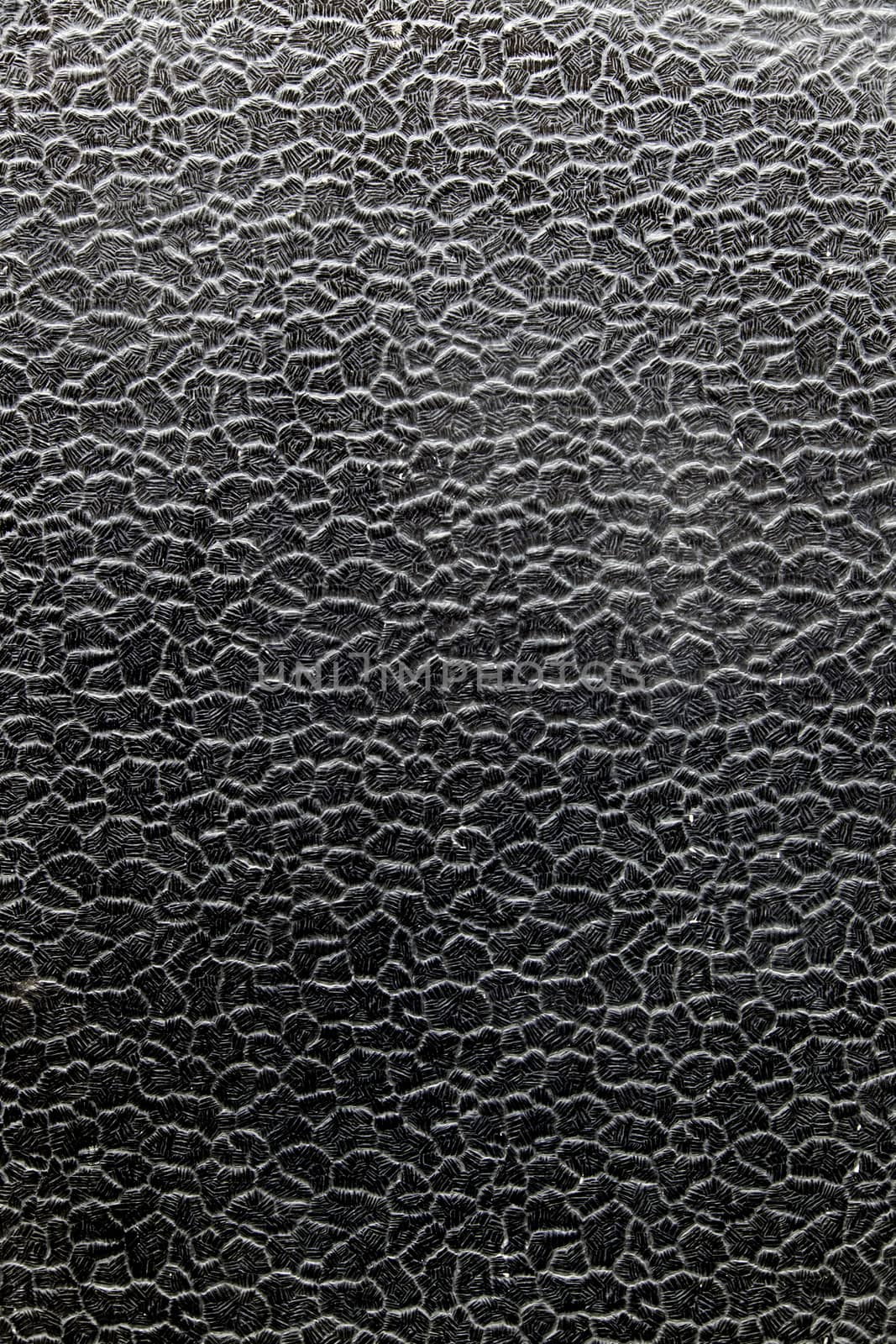 Black crystal with shapes and reliefs, detail of decoration and shapes
