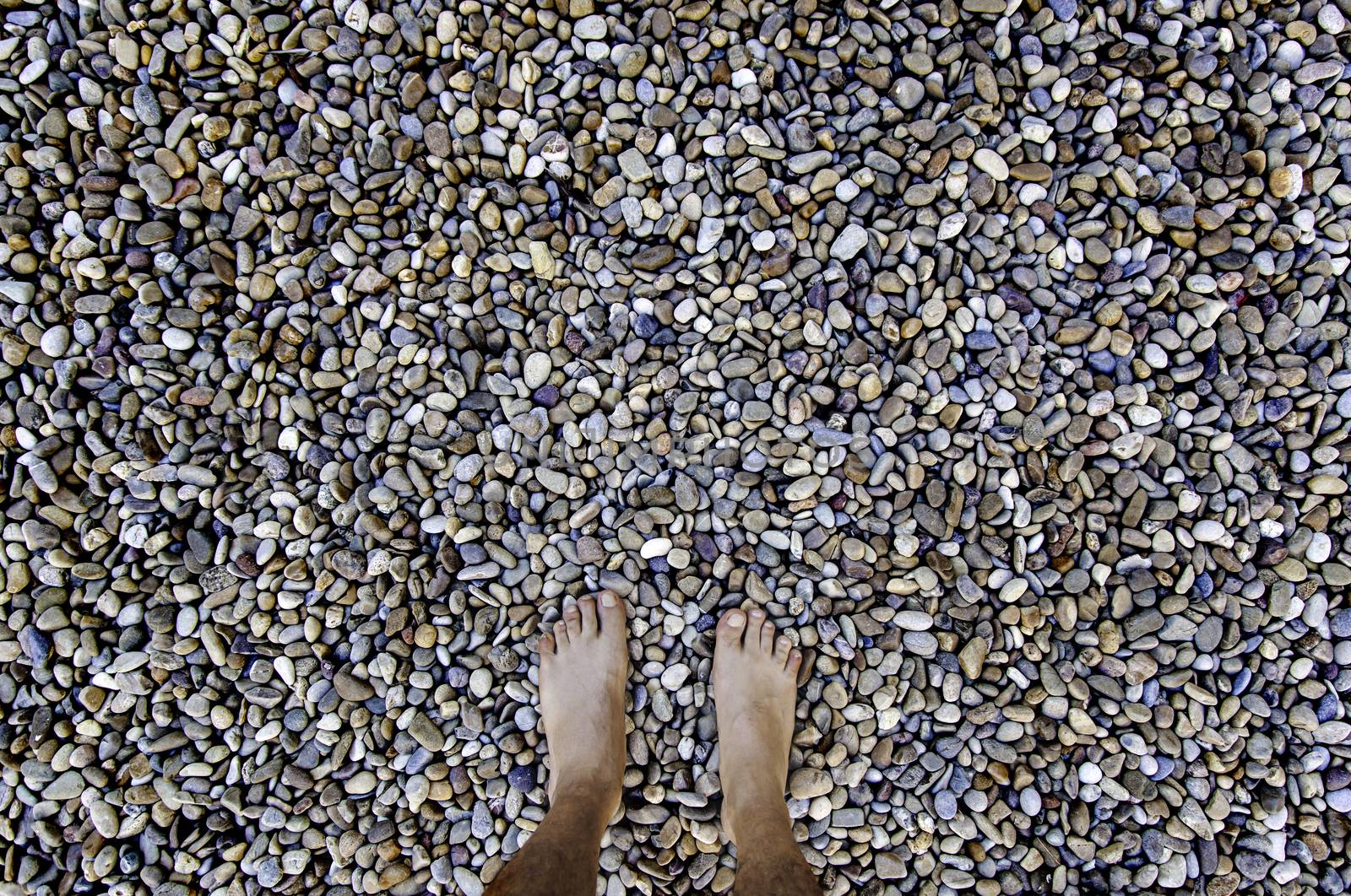 Barefoot feet on a stones, detail of relaxation, spa and zen