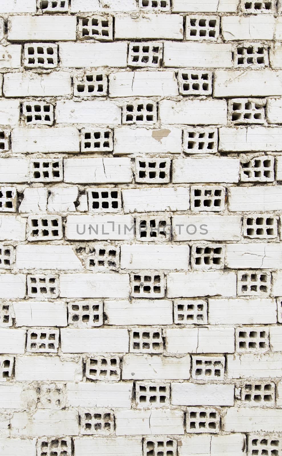 White mud bricks with holes, wall detail under construction