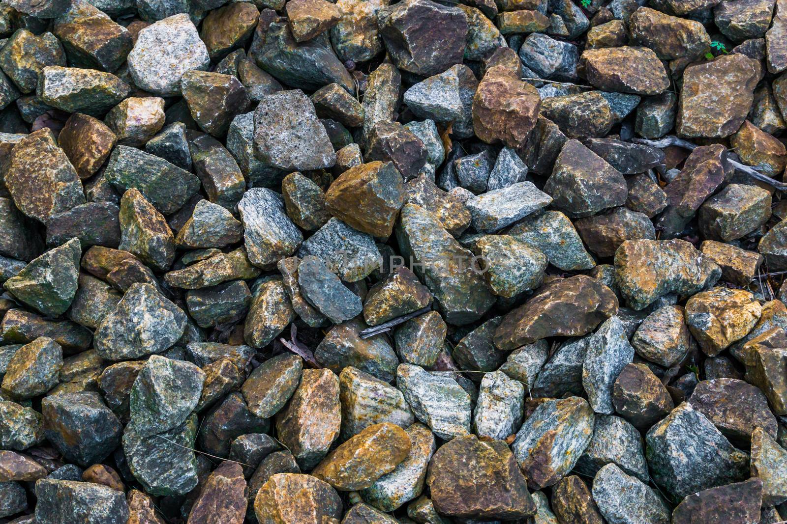 granite pebble stones ground garden decoration in many different colors and shapes macro closeup background by charlottebleijenberg