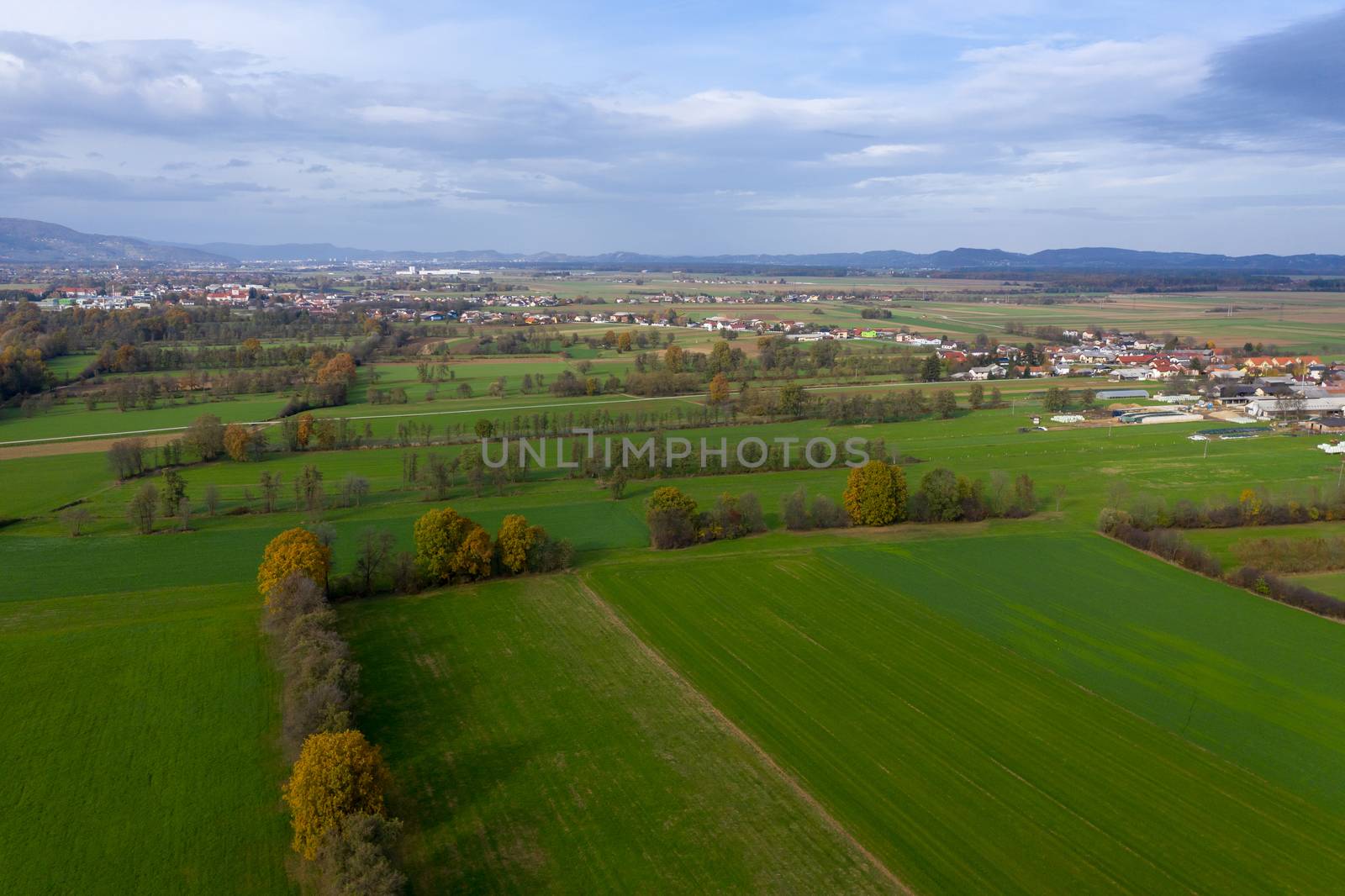 European countryside from the air, village in pannonian plain, Dravsko polje, Slovenia, rural landscape and small villages with houses along the road, villages Podova, Bezula and Race, Slovenia