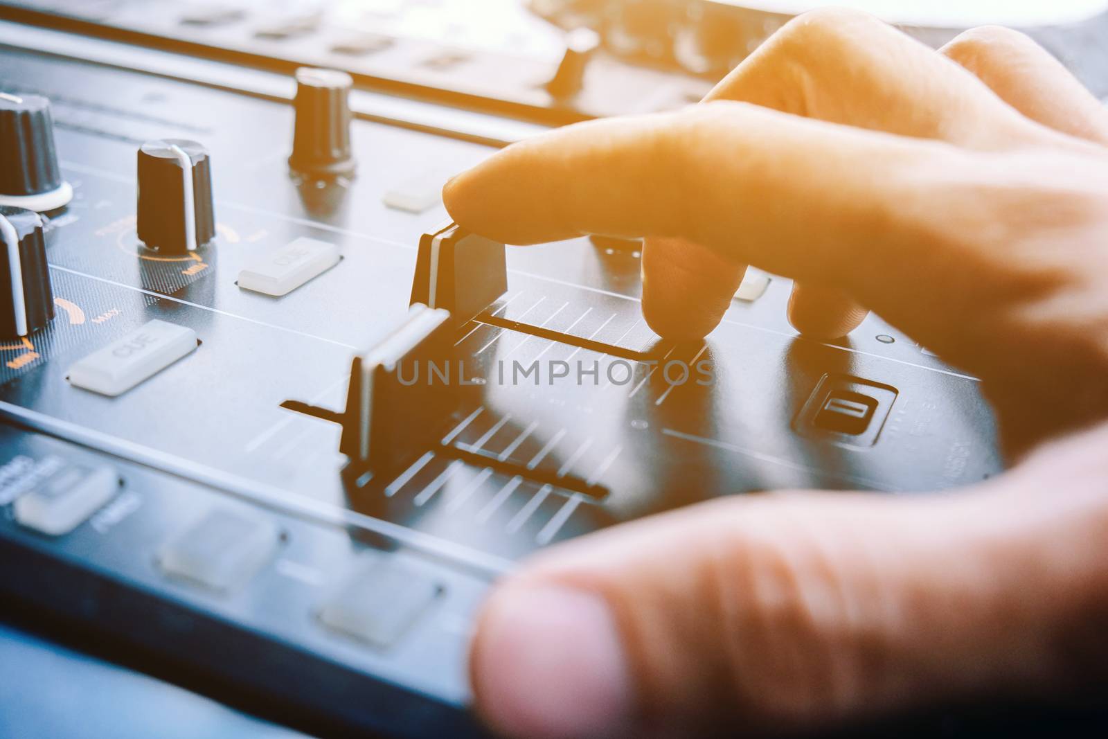 image of Dj playing music at mixer closeup