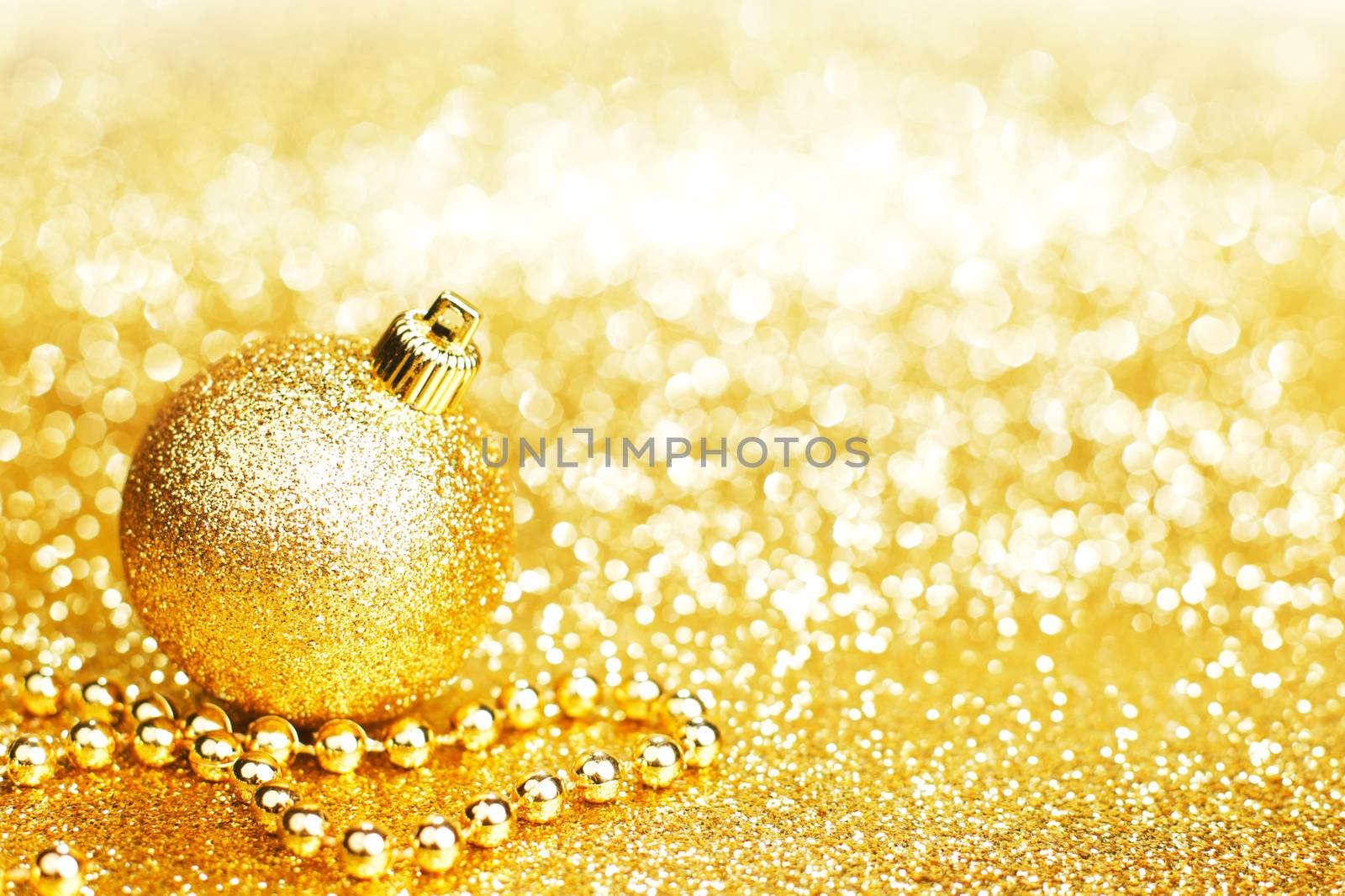 Shiny Golden christmas decor over glitter background