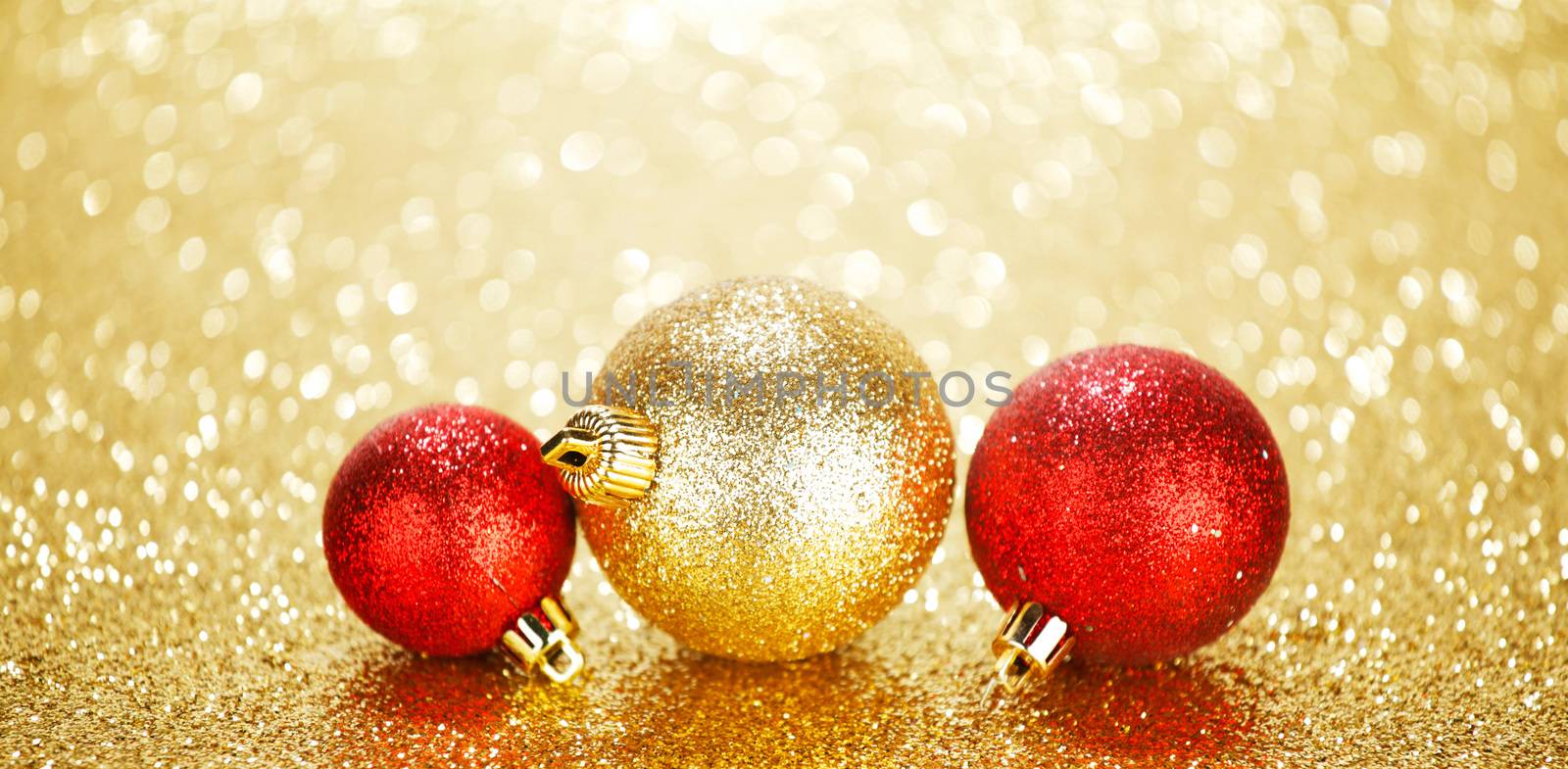 Three beautiful chritmas balls on shiny glitters