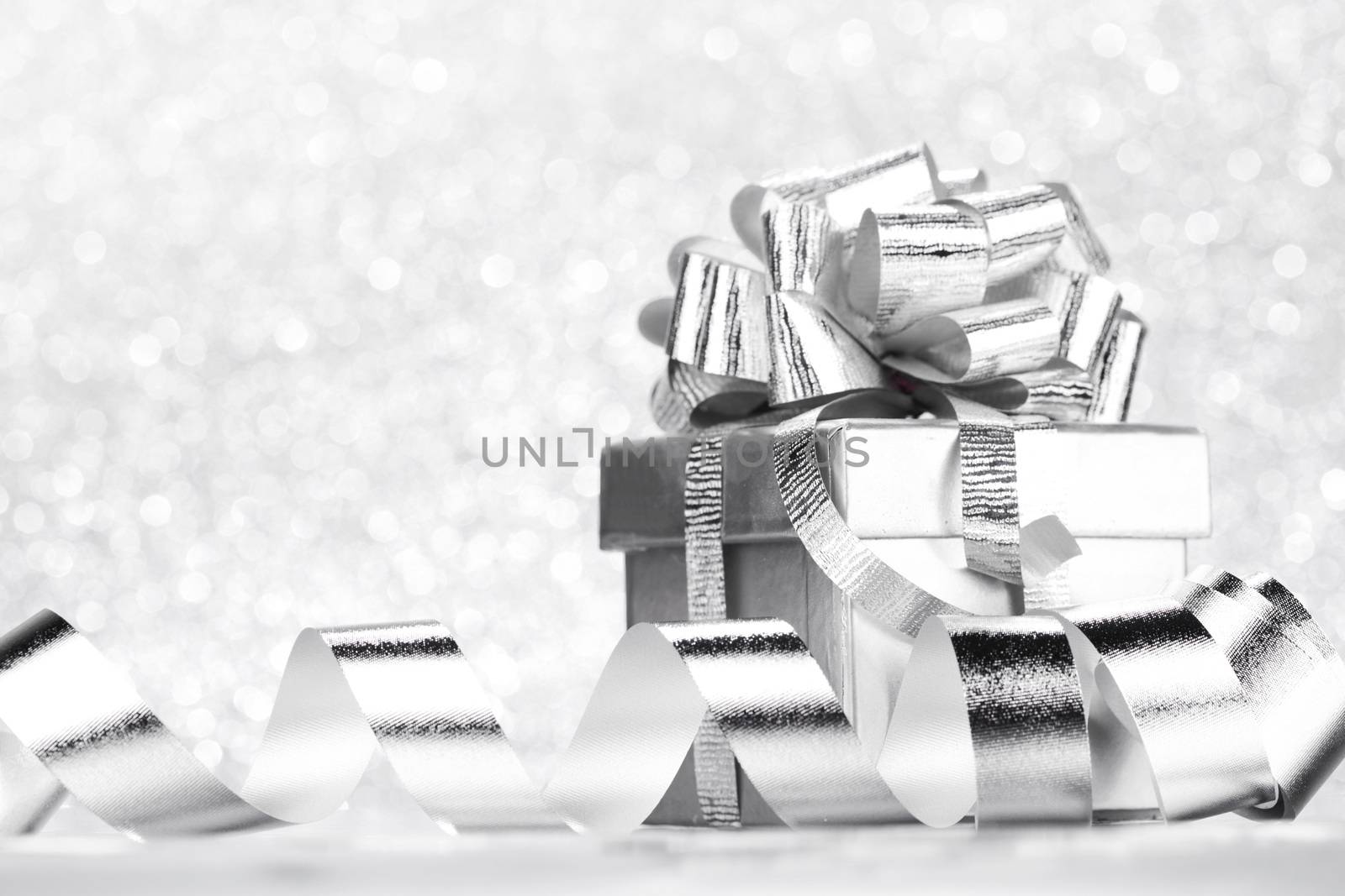 Decorative holiday Gift box and ribbon on bright shiny background