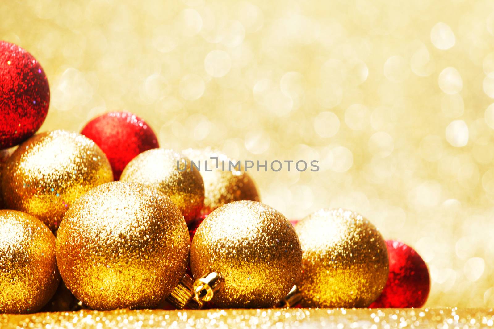 Golden Christmas ball on abstract glitter background