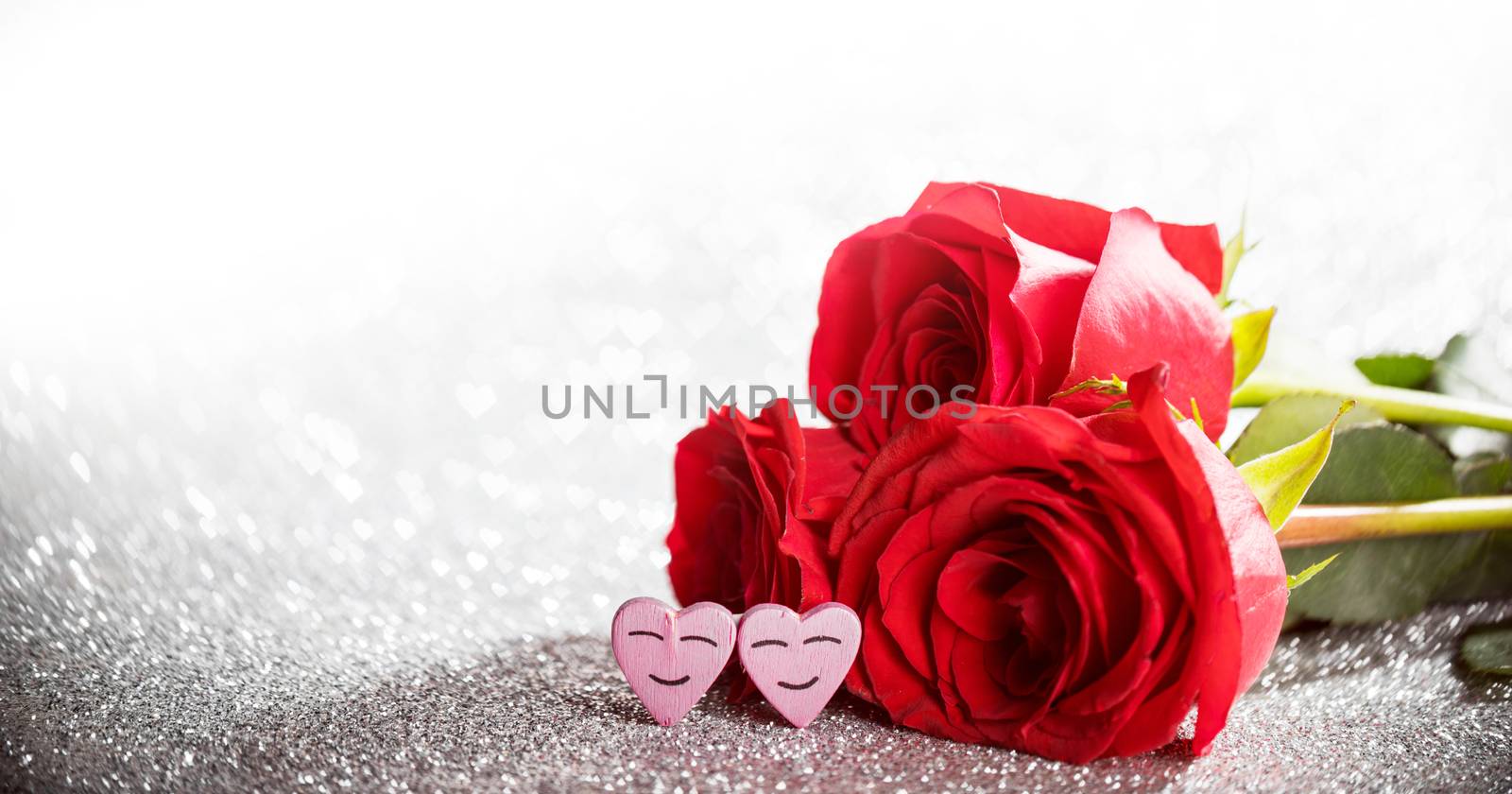 Roses and hearts on silver glowing bokeh hearts background for Valentines day
