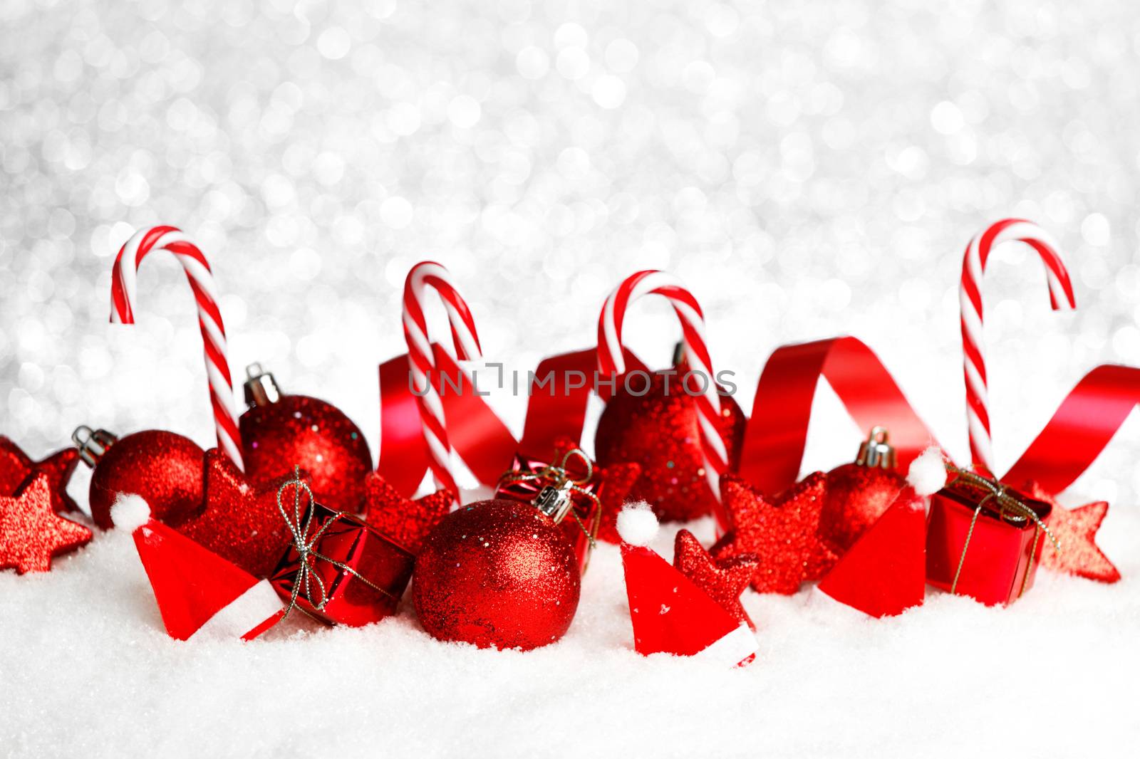 Christmas card with beautiful decorations and candies in snow