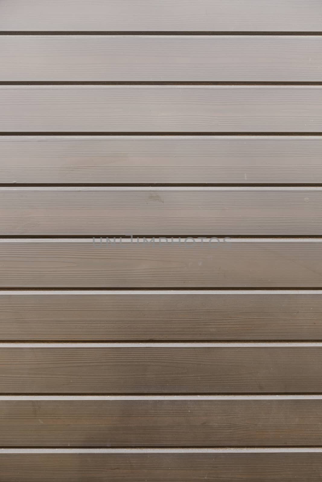 Bright Wooden background detail of a wall decorated with wooden boards