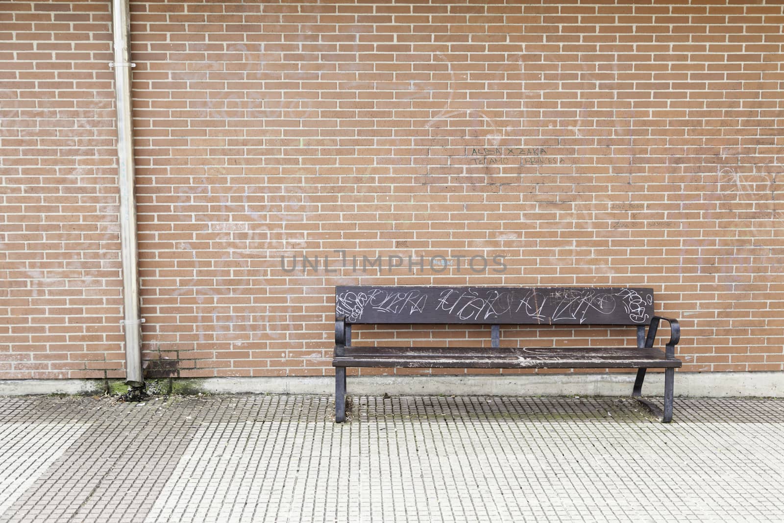 Wooden seat in the city, details of street furniture in the city bench to rest