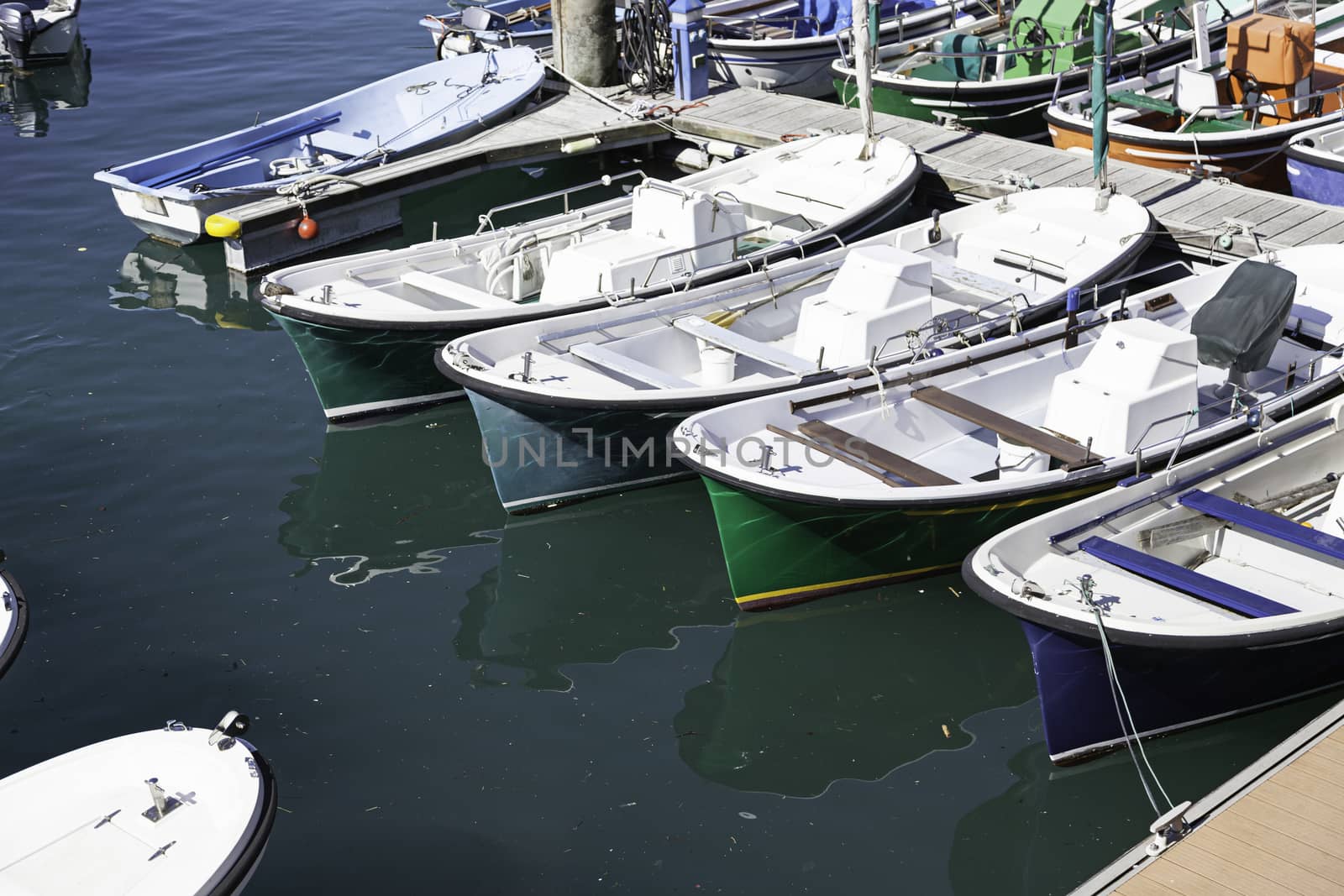 Boats moored on a seaside pier by esebene