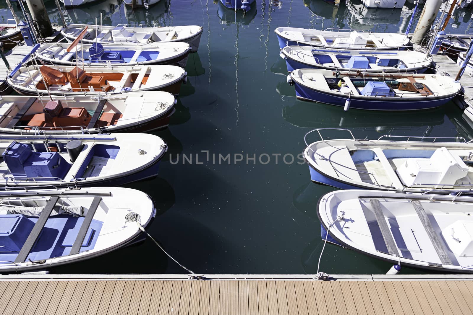 Boats moored at a marine dock, detail of recreational boats on a dock, fishing and fun, sea transport