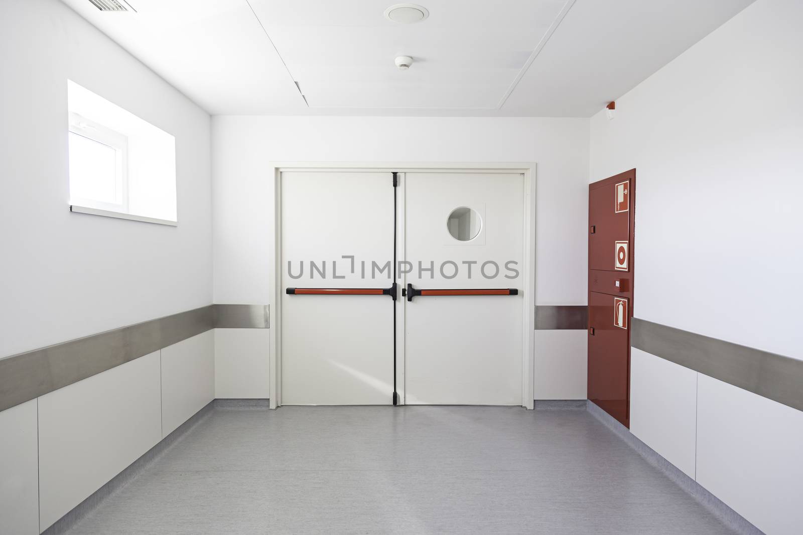 Deep hospital corridor, detail of a white corridor in a hospital, architecture and health