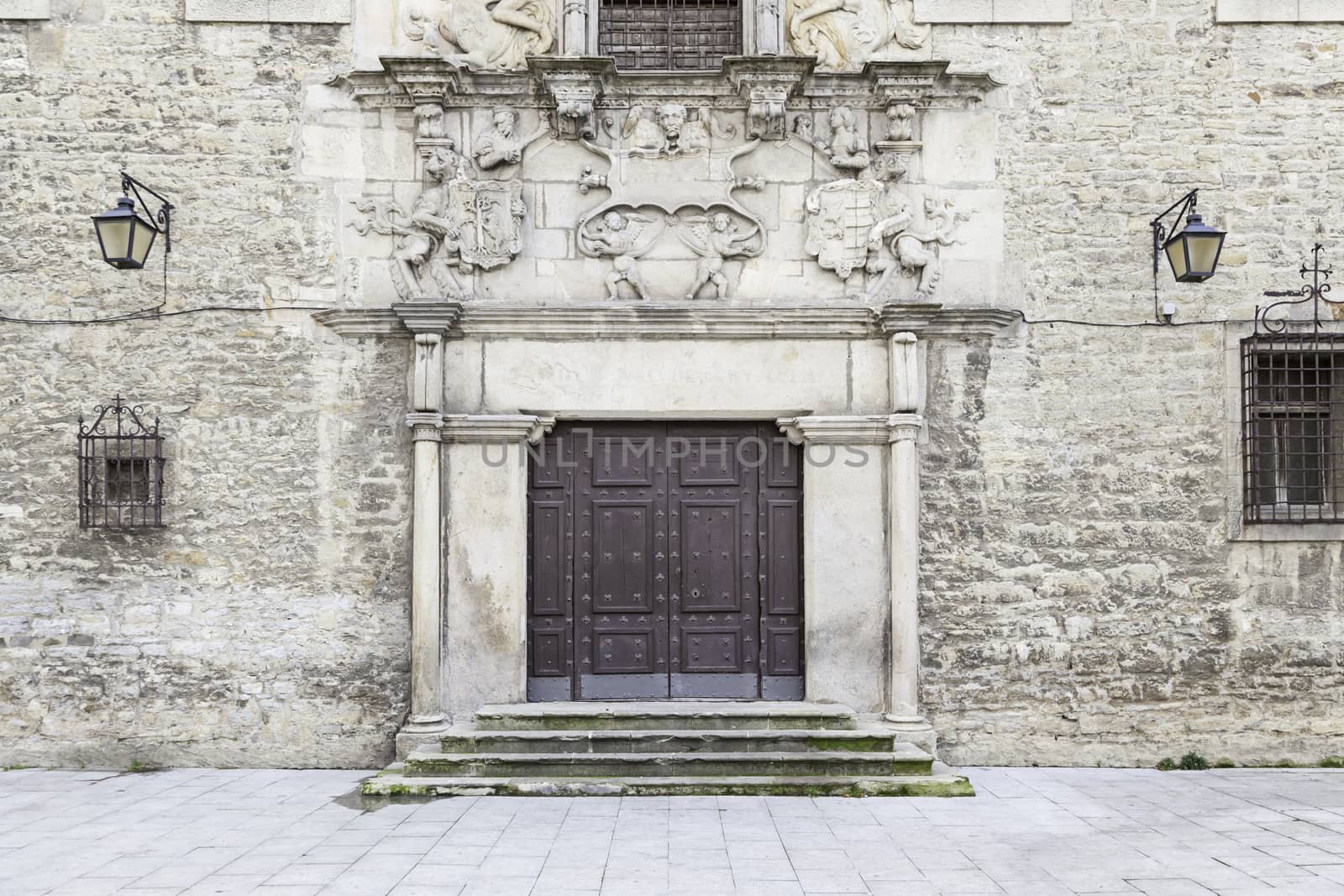 Old door in a historic building, detail of a wooden door in a very old building, background and history