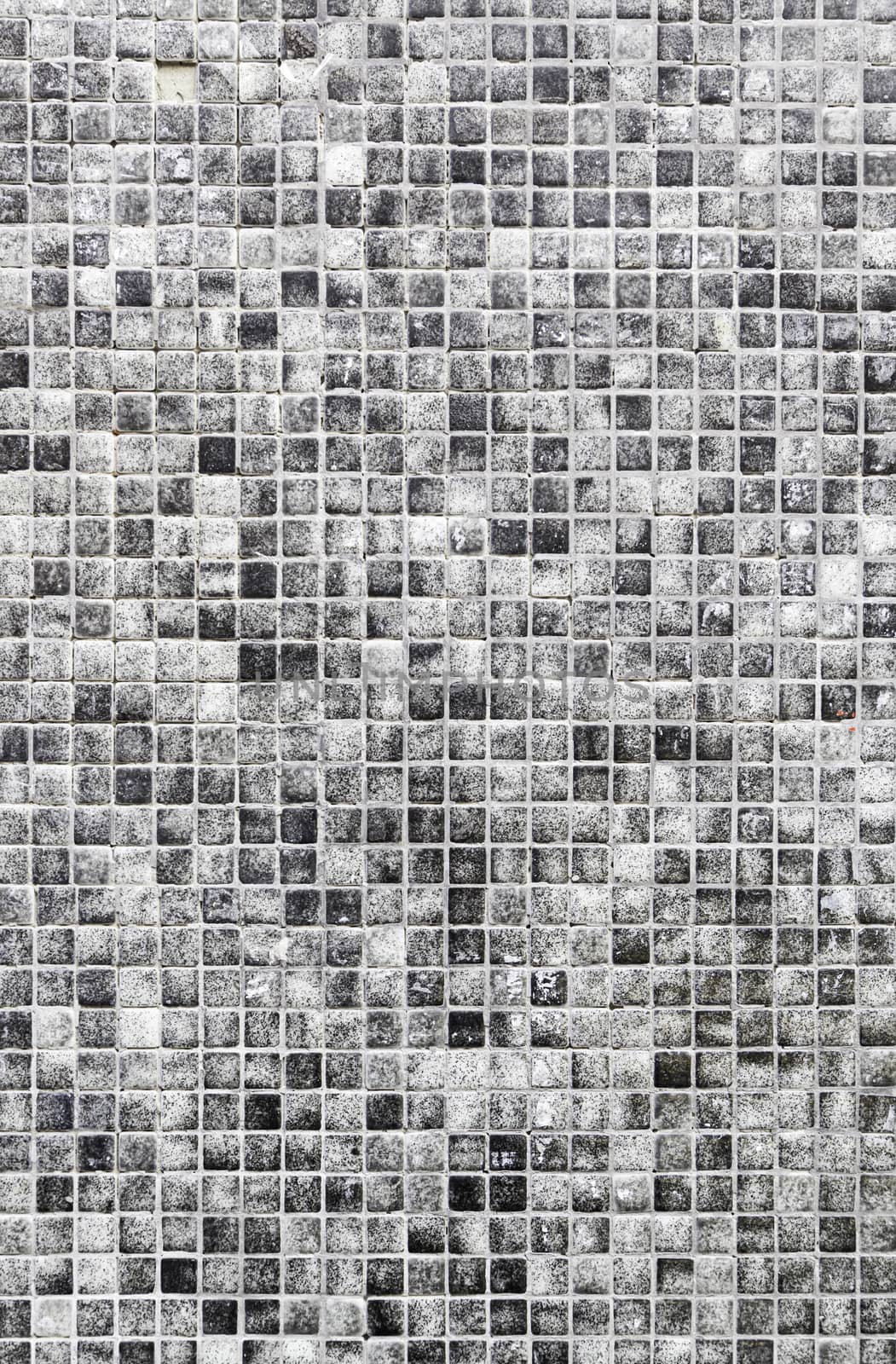 Gray mosaic tile detail of a wall decorated with tiles, interior decoration