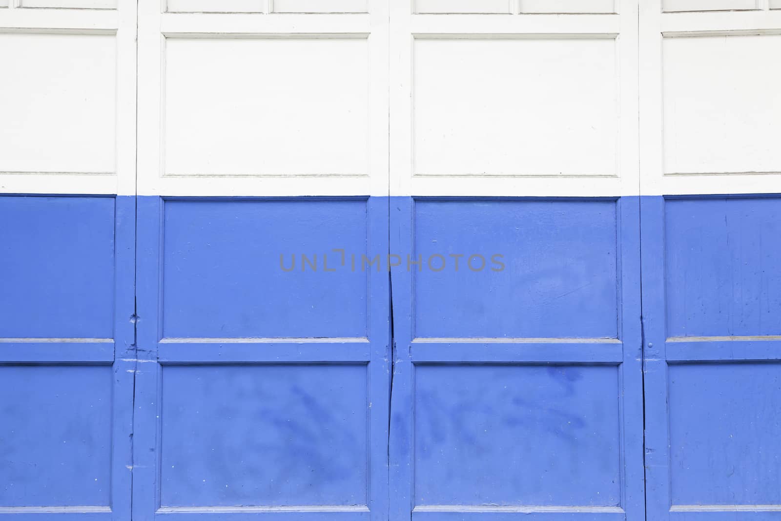 Blue and white door, detail of a door in a city, painting and decoration, protection, closed