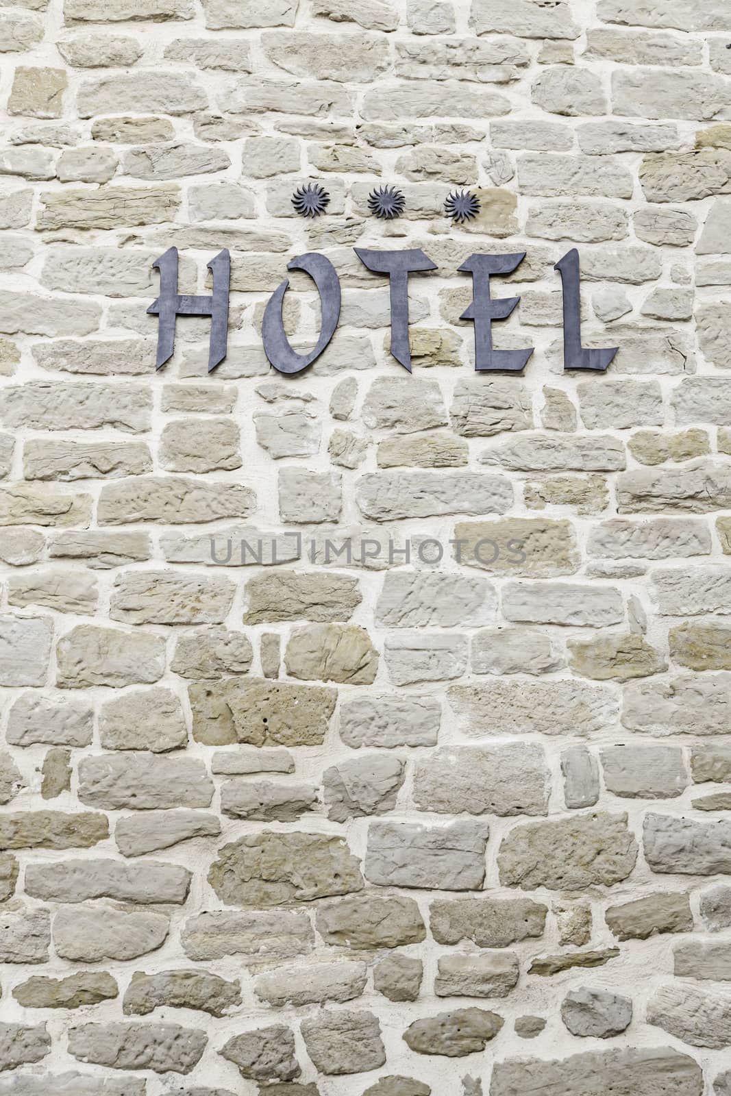 Hotel sign on a wall, detail of an information signal, three star hotel