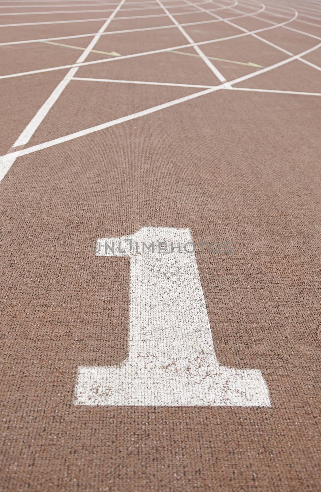 Running track with number one, detail of a running track, with the starting line number one, textured background, sport