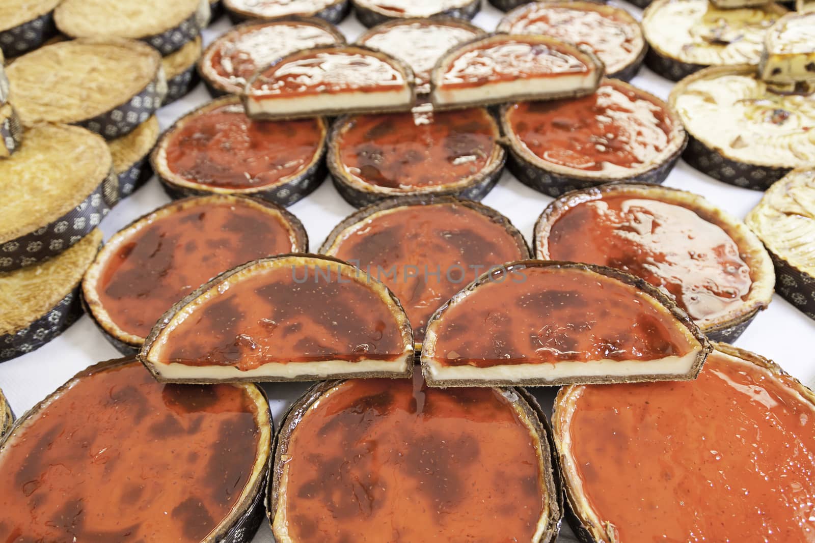 Strawberry cakes in a market, a detail of homemade desserts in a store, healthy food, sugar and fruit