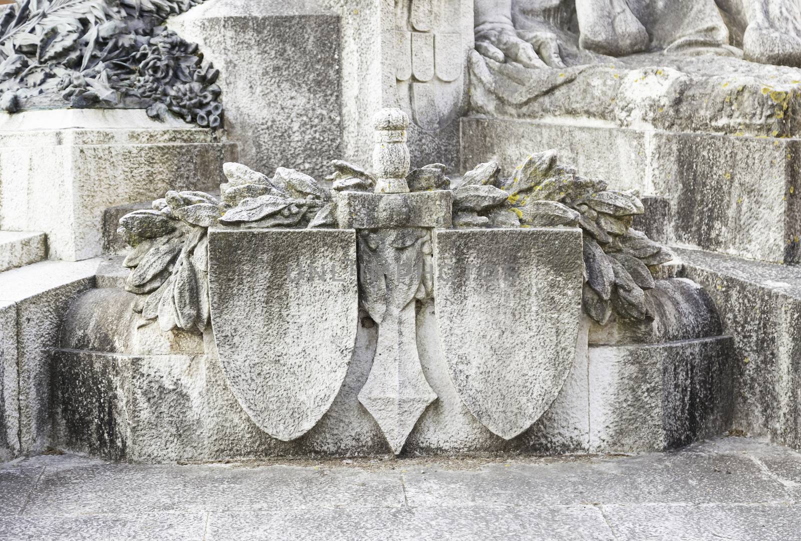 Statue with shield and sword, detail of a war memorial statue, art in the city