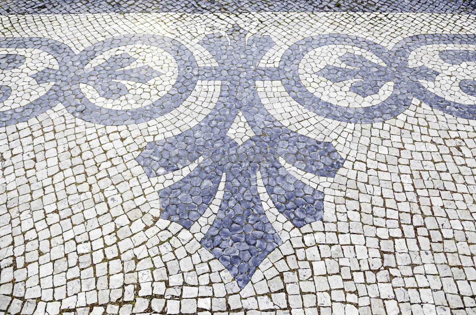 Lisbon typical mosaic, detail of a typical floor of Portugal, decorative mosaic on a typical street of Lisbon