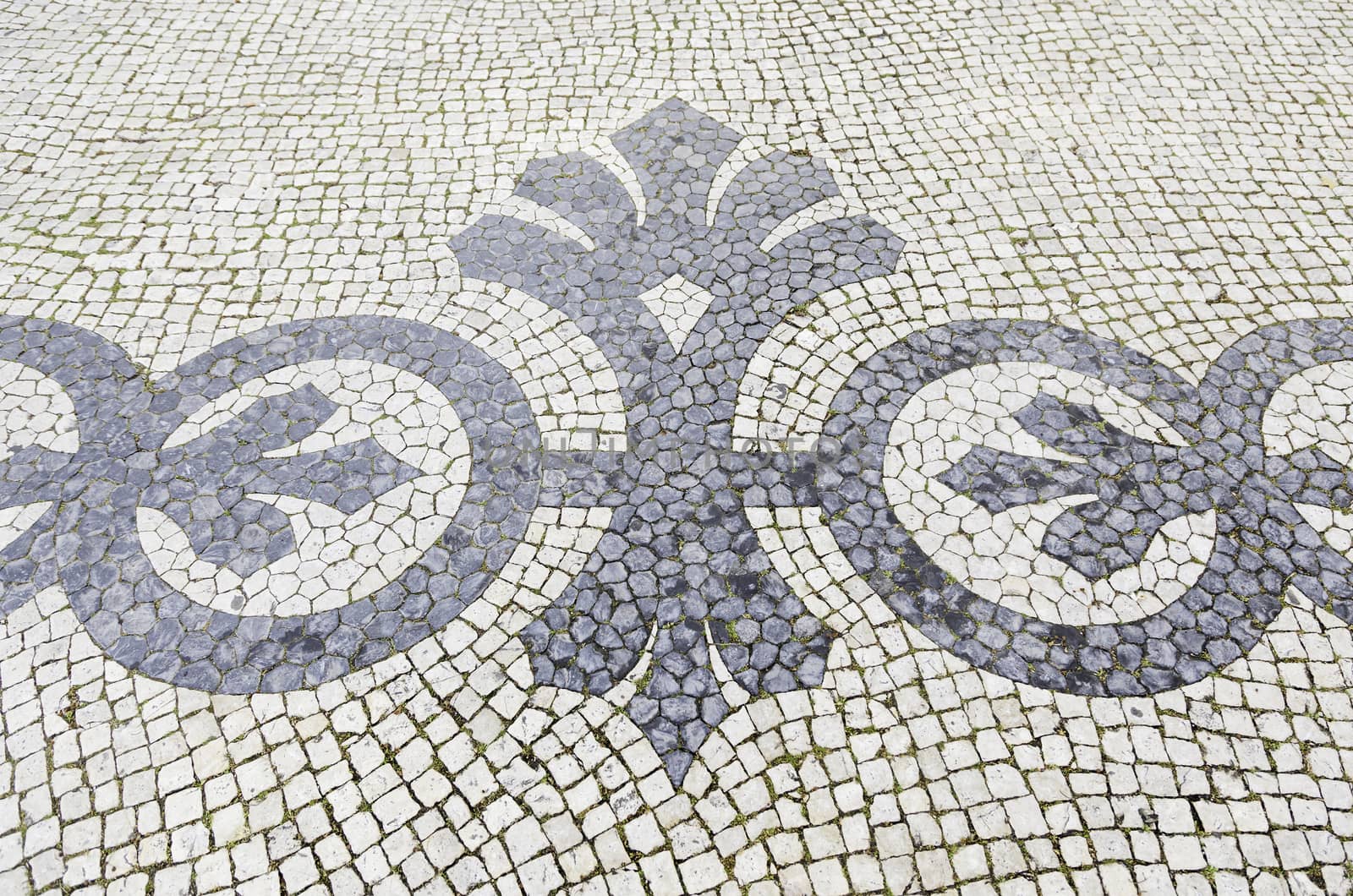 Lisbon typical mosaic, detail of a typical floor of Portugal, decorative mosaic on a typical street of Lisbon