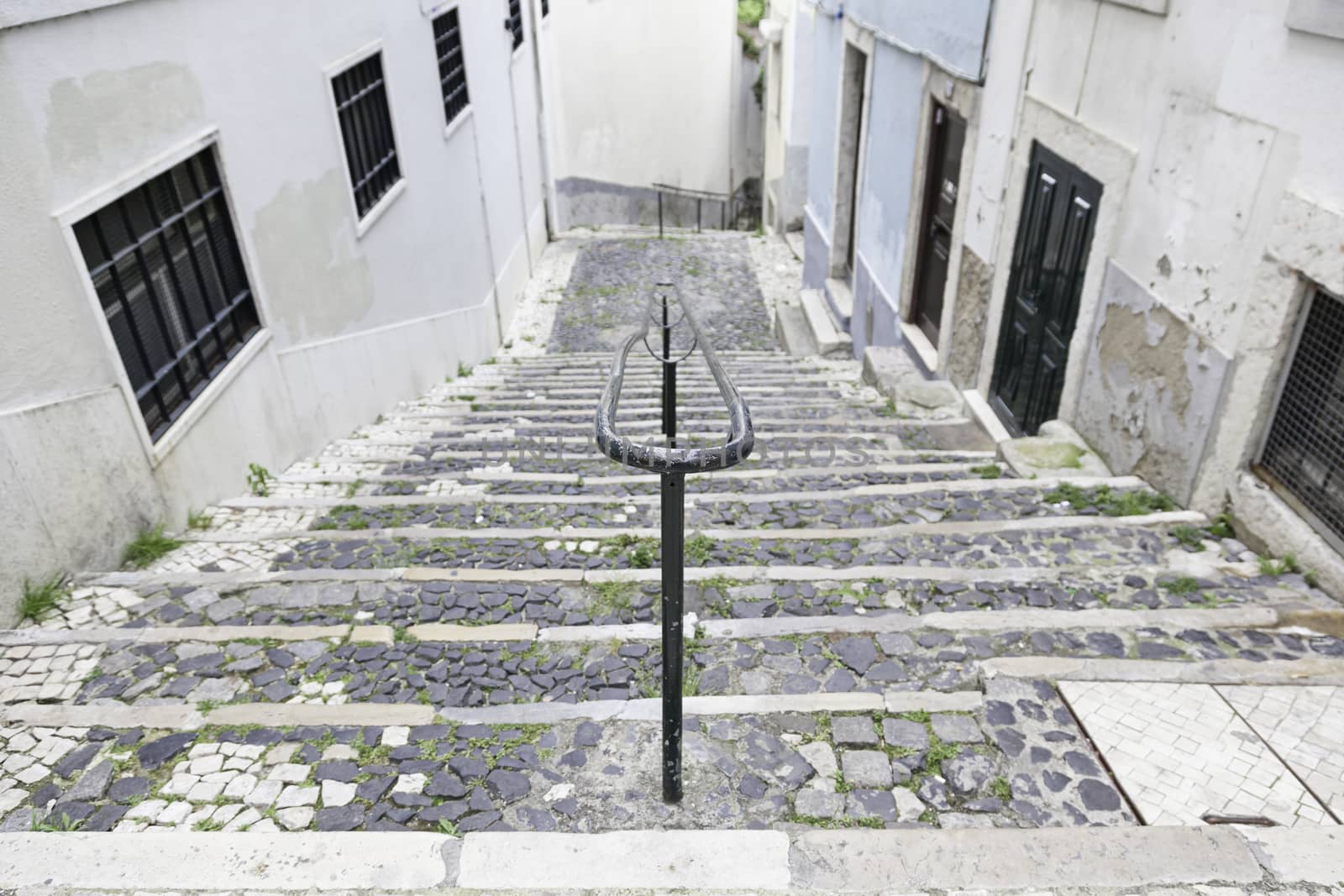 Old stone stairs in Lisbon, detail of stairs in an old street in an old neighborhood in Portugal