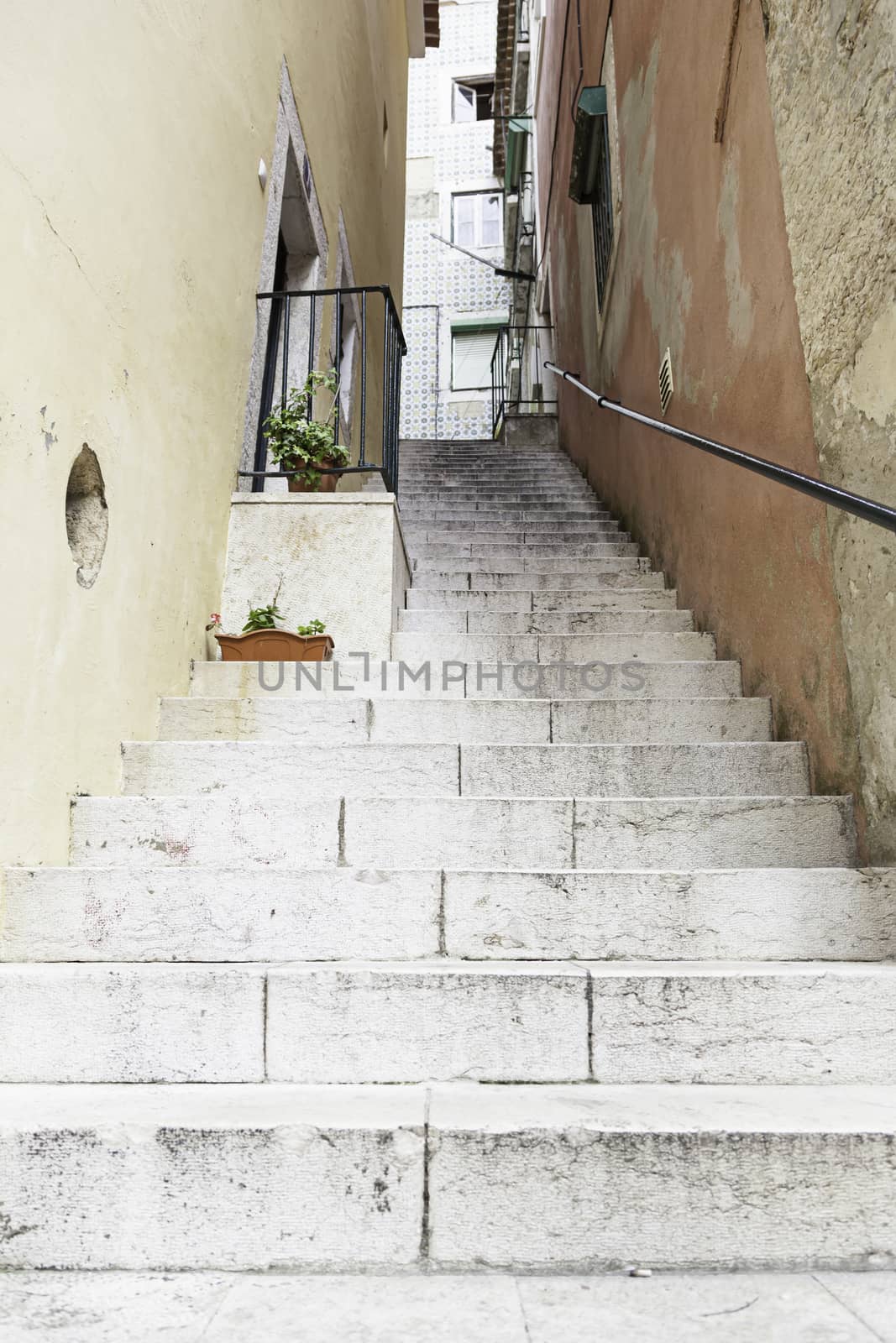 Old stone stairs in Lisbon, detail of stairs in an old street in an old neighborhood in Portugal